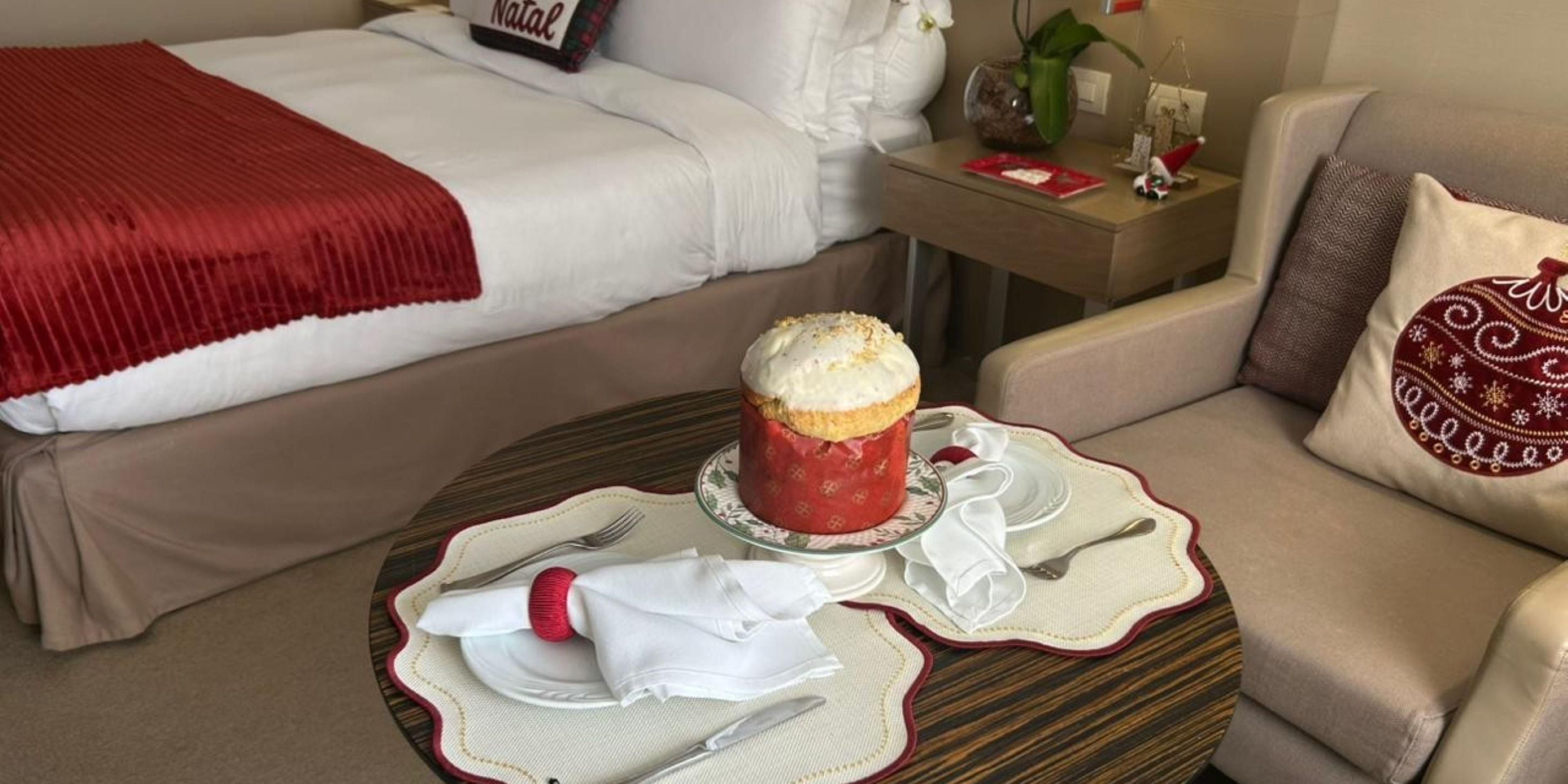 Step into a festive haven with our beautifully decorated Christmas Suite, designed to immerse you in holiday cheer. Enjoy traditional delights like freshly baked panettone and gingerbread, perfectly paired with a bottle of sparkling wine to toast the season. Book your cozy and luxurious retreat to make your holiday stay truly unforgettable.