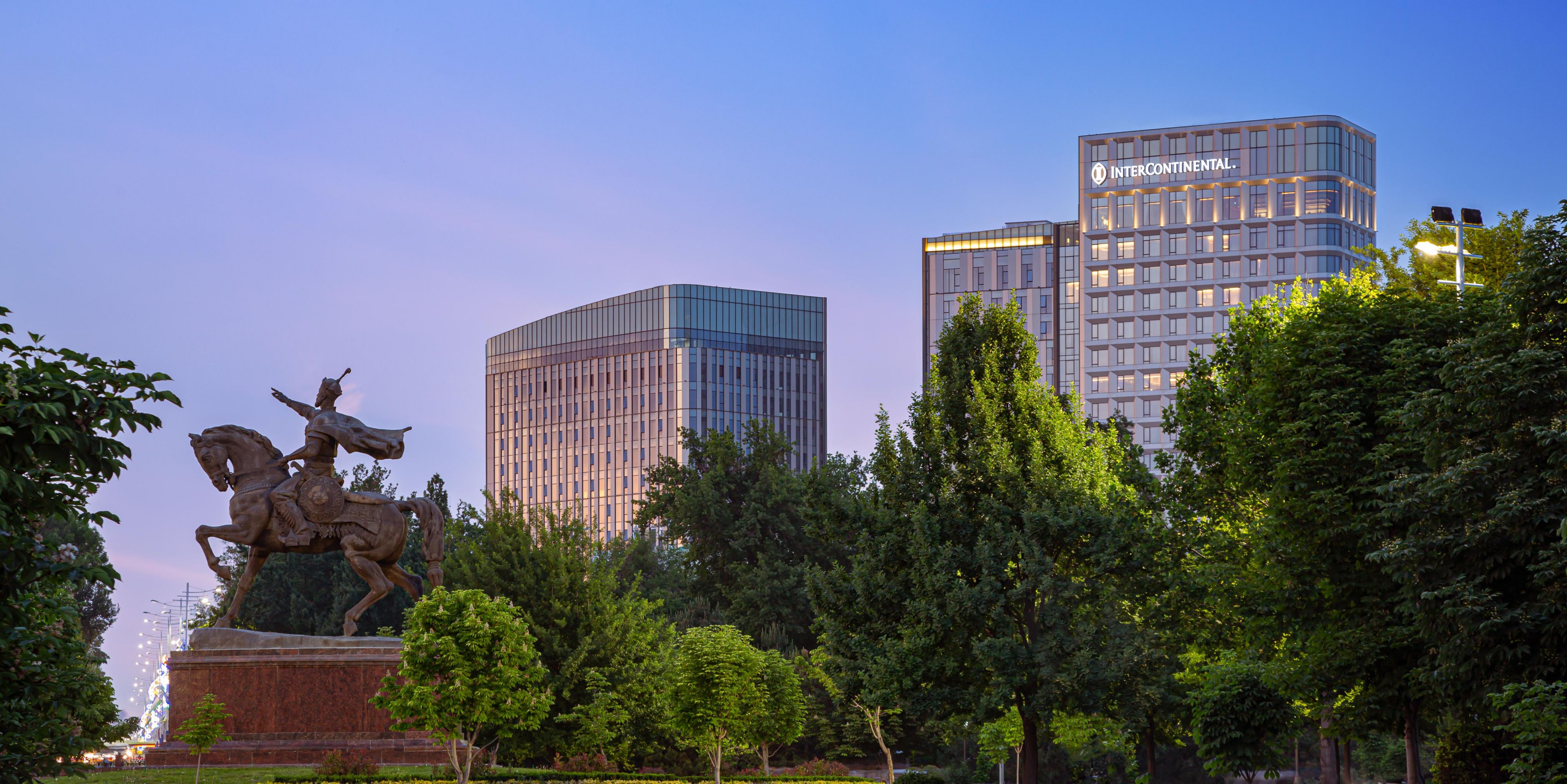 The hotel windows open up to the lush green Amir Temur Square.