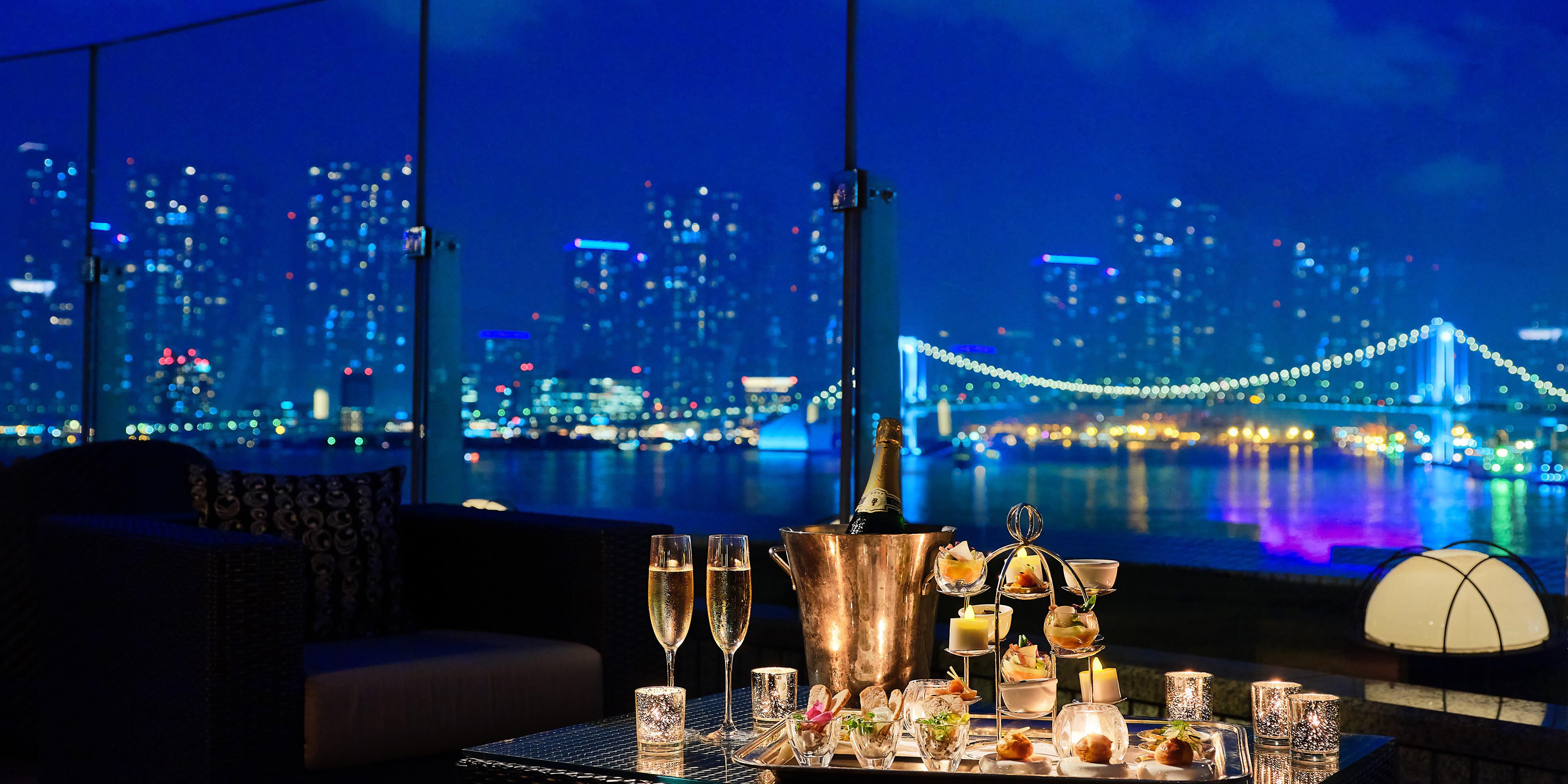 Enjoy high-tea style hors d'oeuvres and free-flowing Champagne on the rooftop terrace of Manhattan, the only restaurant at Hotel InterContinental Tokyo Bay with sweeping views of Tokyo Bay and Rainbow Bridge—a perfect blend of gourmet elegance and scenic beauty.