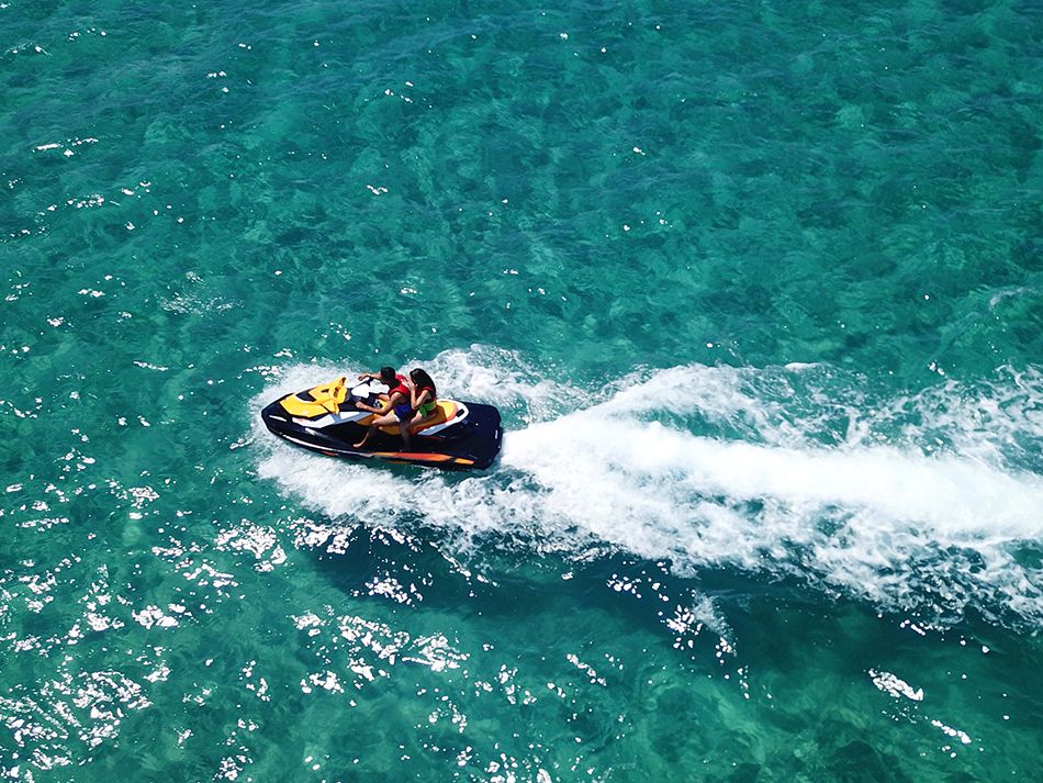 Couple on jet ski in ocean