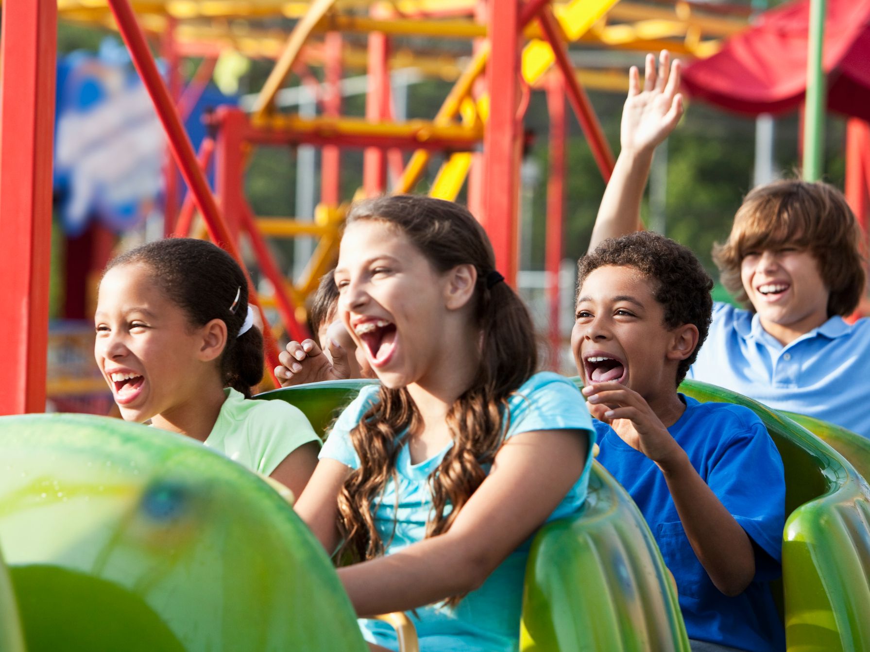 Kids enjoying a roller coaster