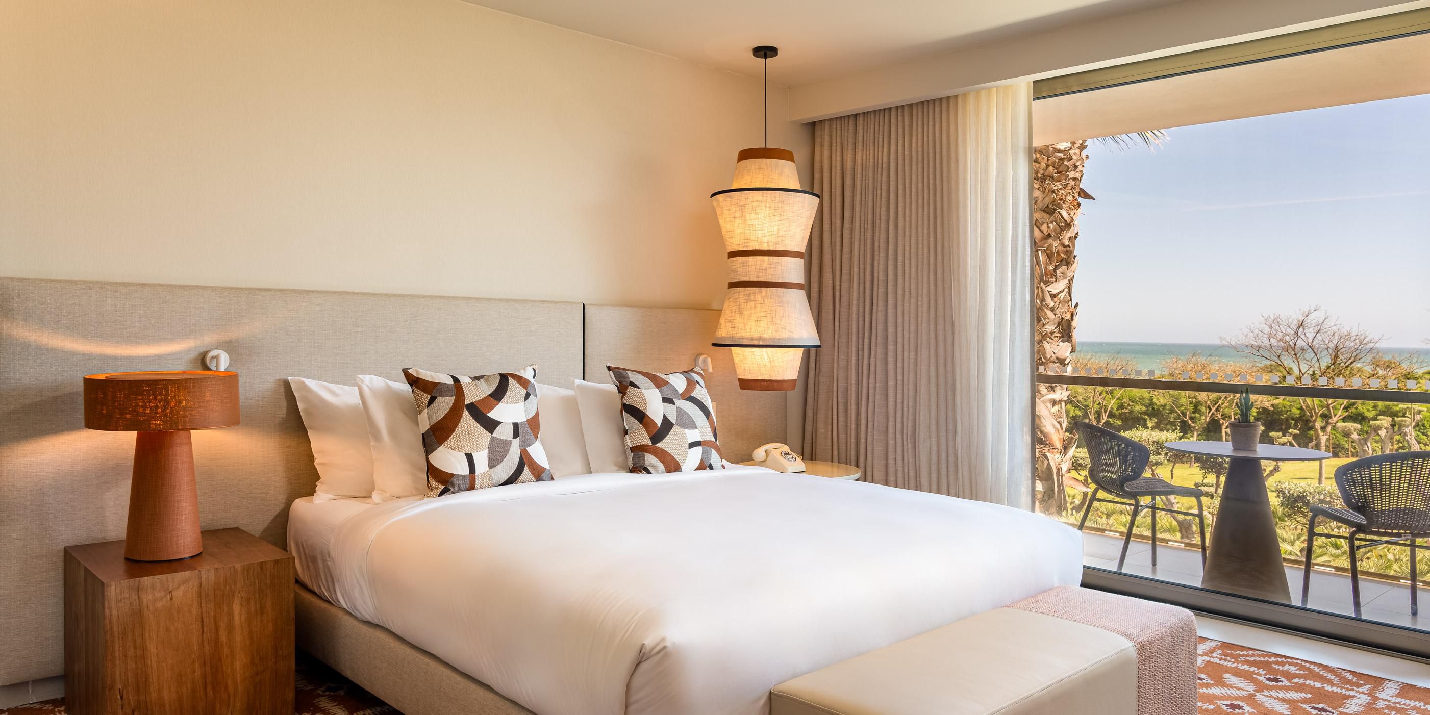Unwind in refined guest rooms and suites where contemporary comfort meets Algarve authenticity. Overlooking the sea or lush gardens, each space is crafted for relaxation with soft textures, warm tones, and an understated, elegant atmosphere that soothes and inspires.