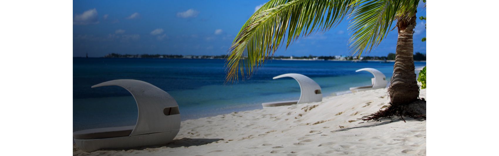 白色沙滩两旁是面朝翠蓝色大海的小屋