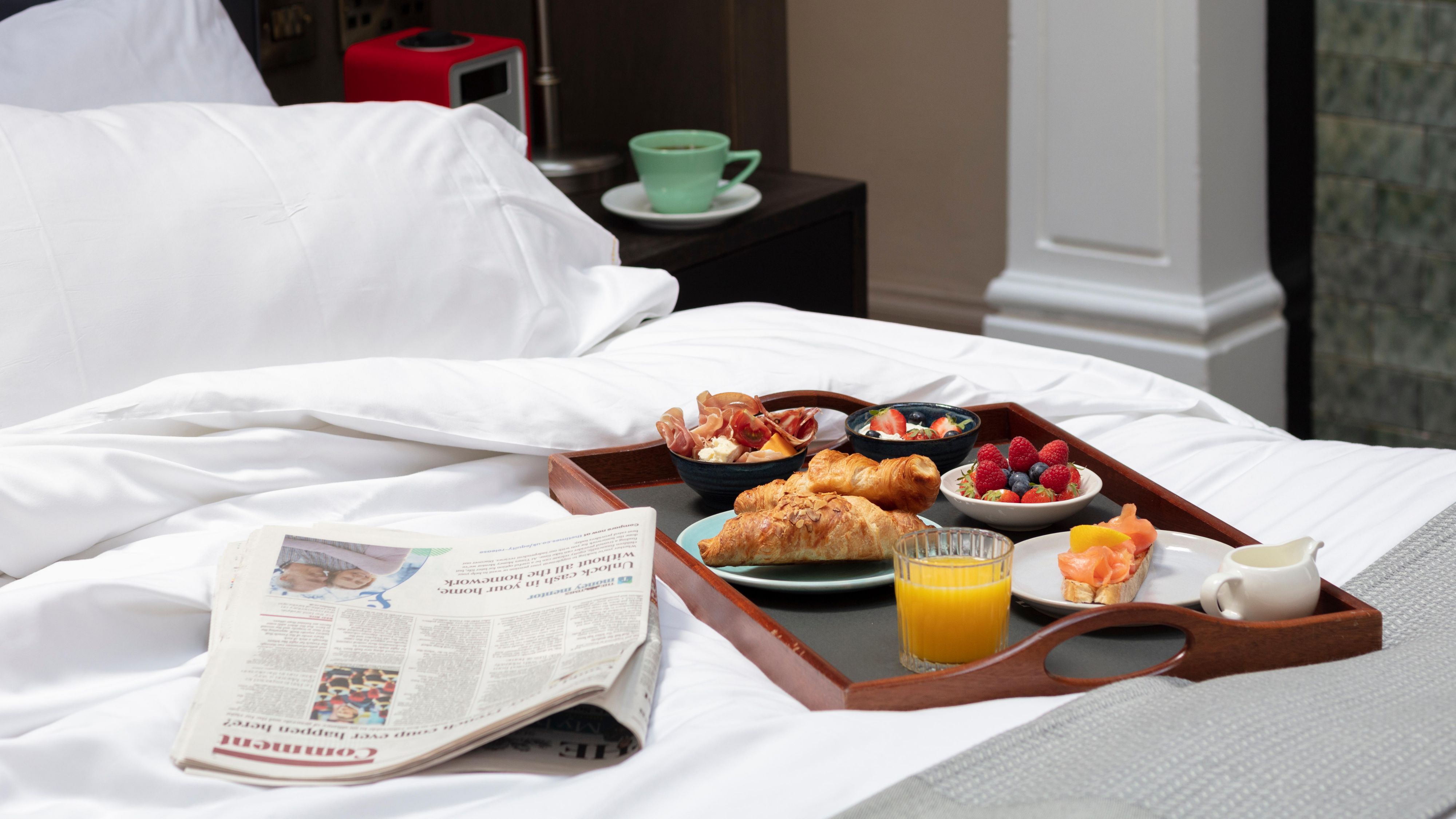 Room service breakfast on a bed