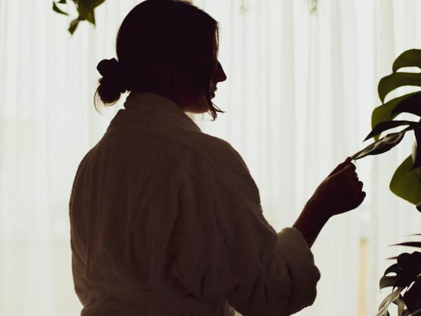 Woman looking at a plant