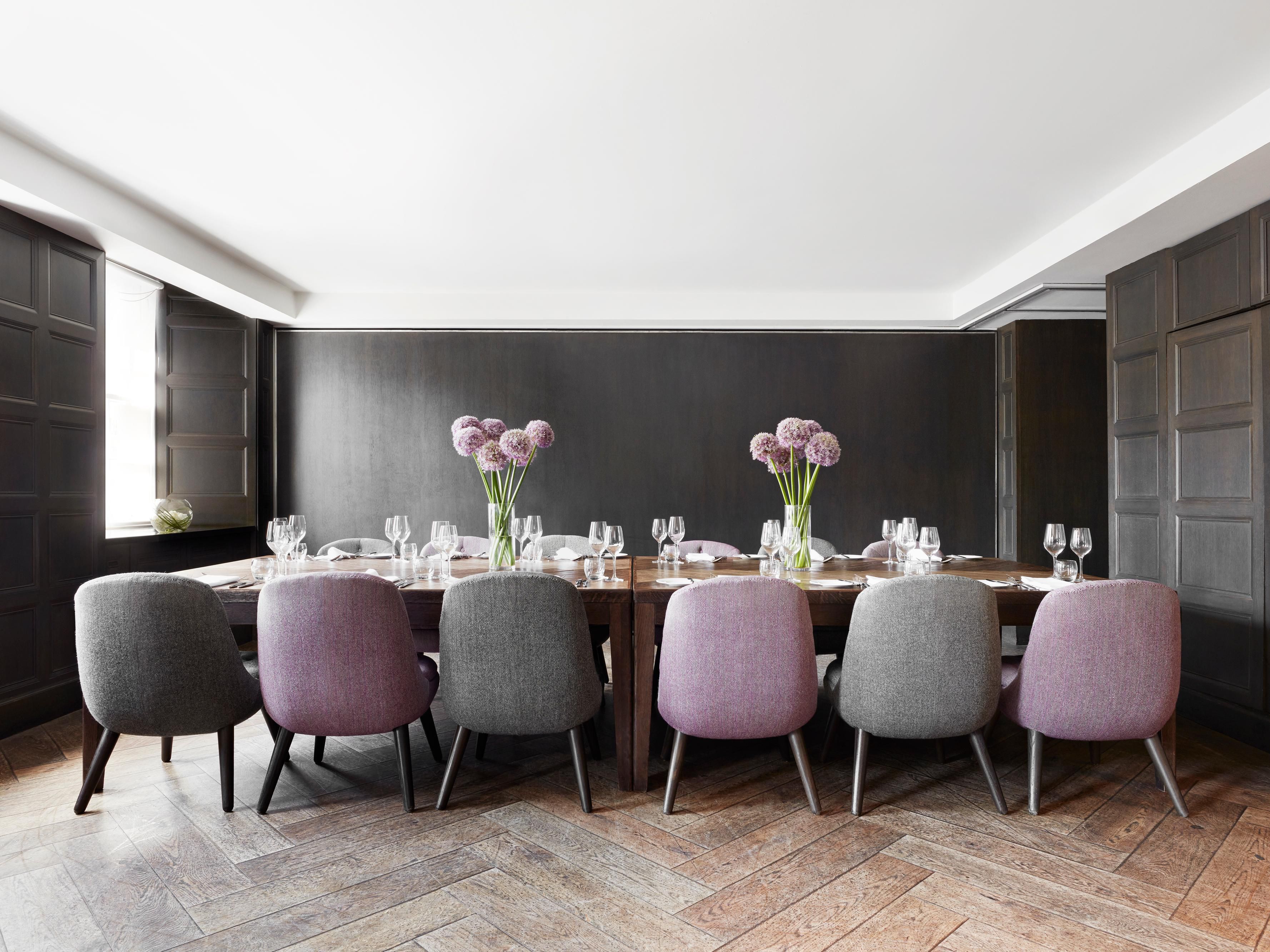 Empty luxury hotel meeting room with purple and grey chairs