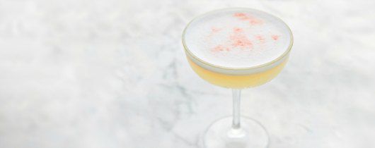 白色大理石桌，上面放置着赏心悦目的白色、粉色和金色鸡尾酒