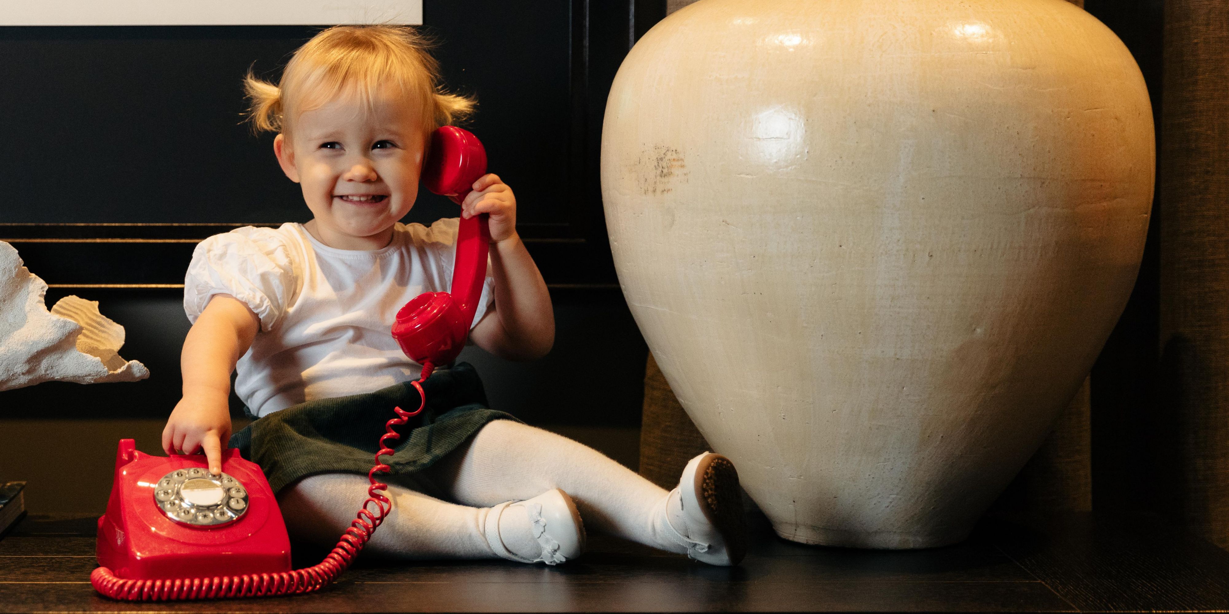 Little girl on old school telephone