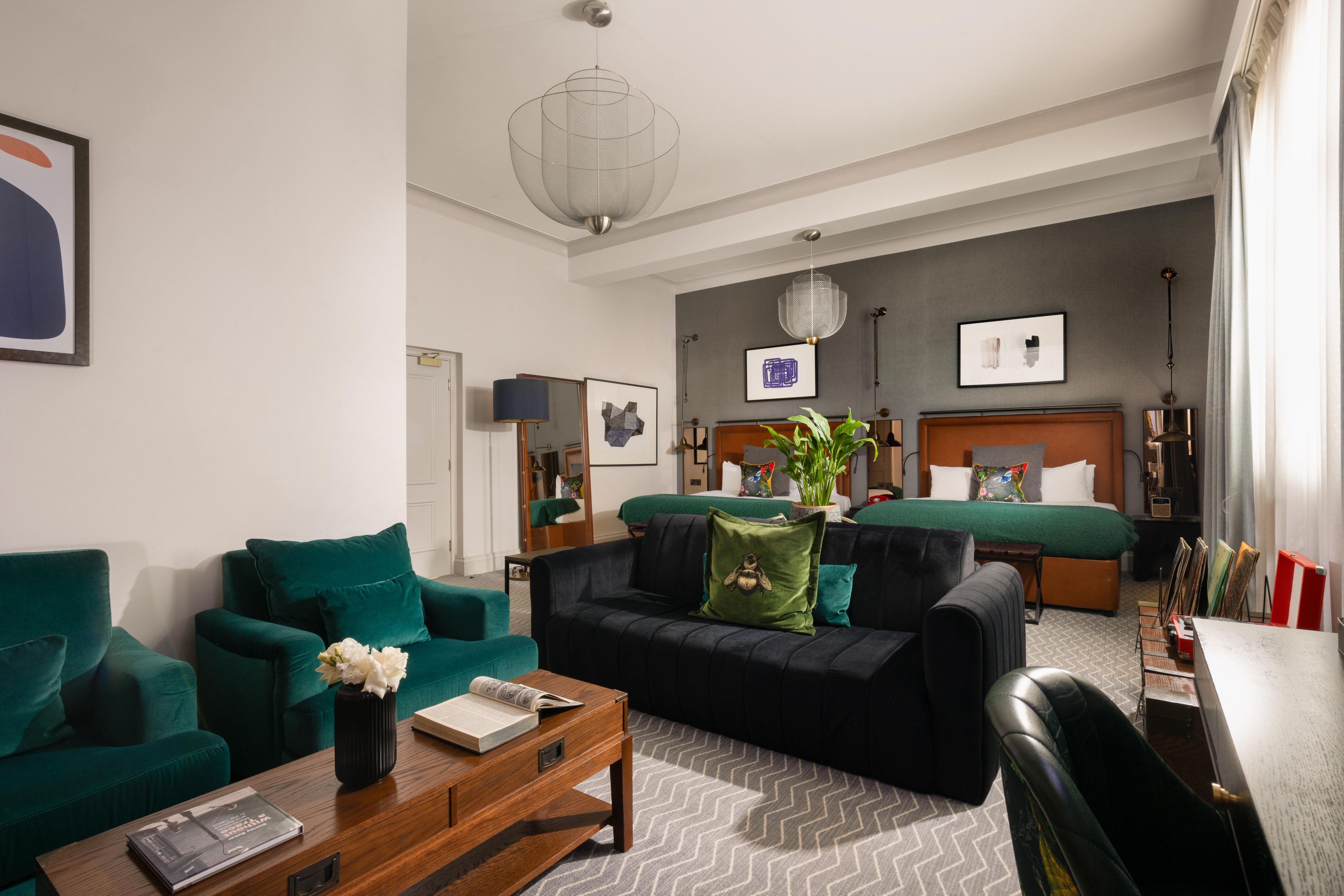 2 king sized beds in a luxury hotel king suite with featured lounge area