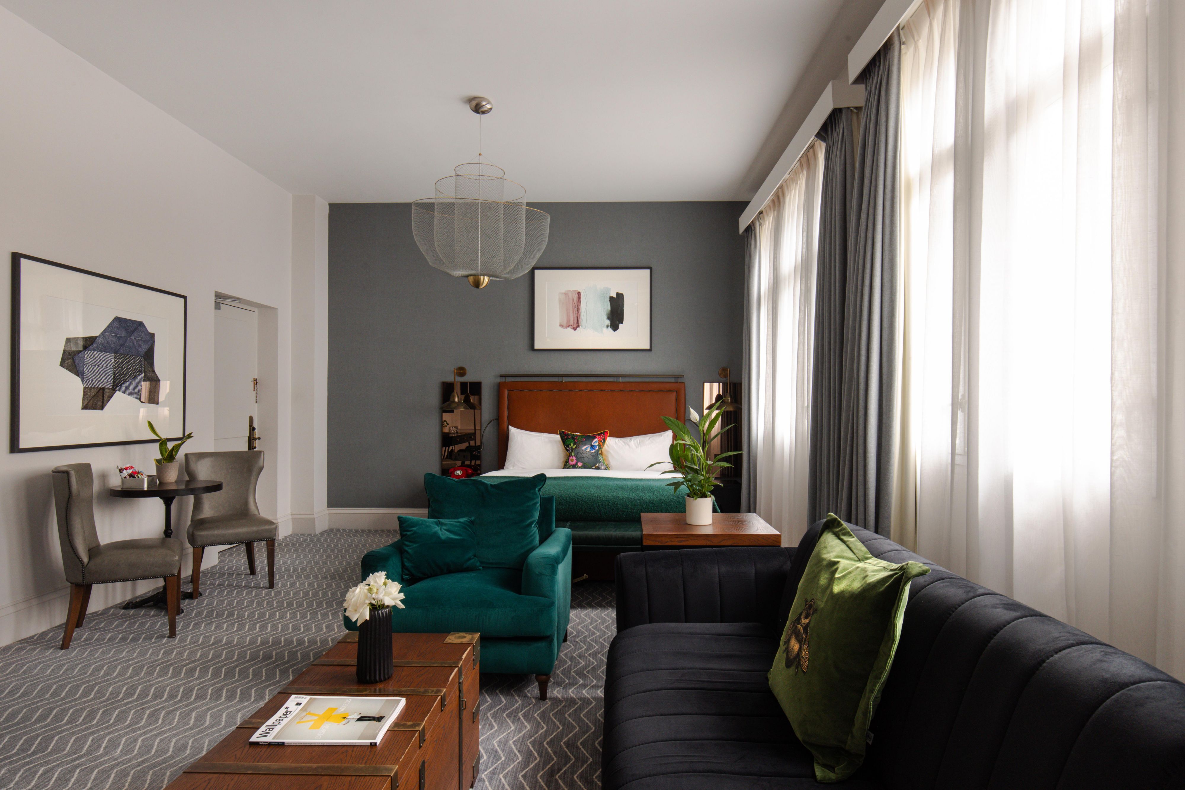 Lounge area in a hotel luxury suite with king sized bed in view