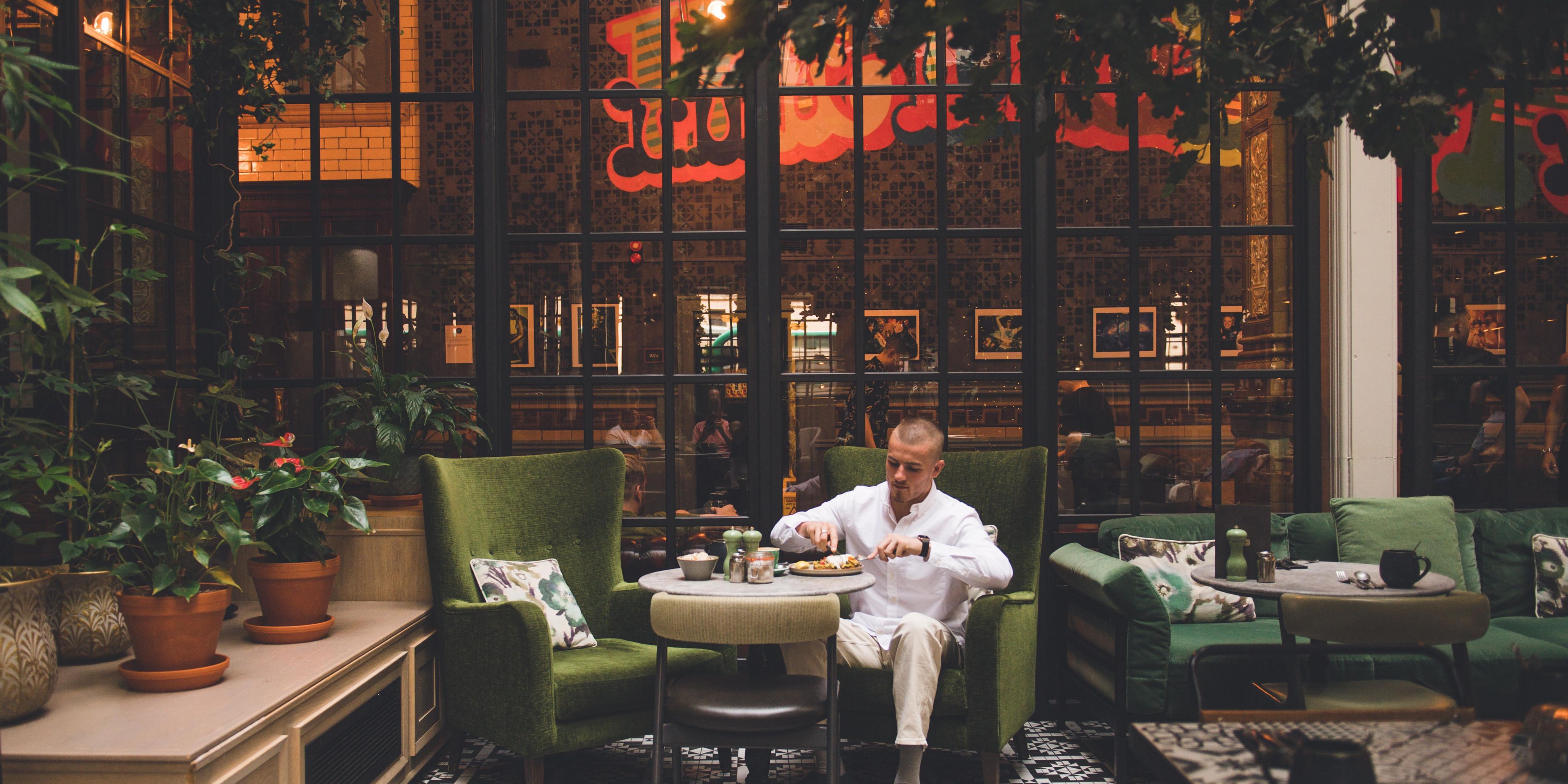 hotel guest relaxing and eating in hotel restauarnt