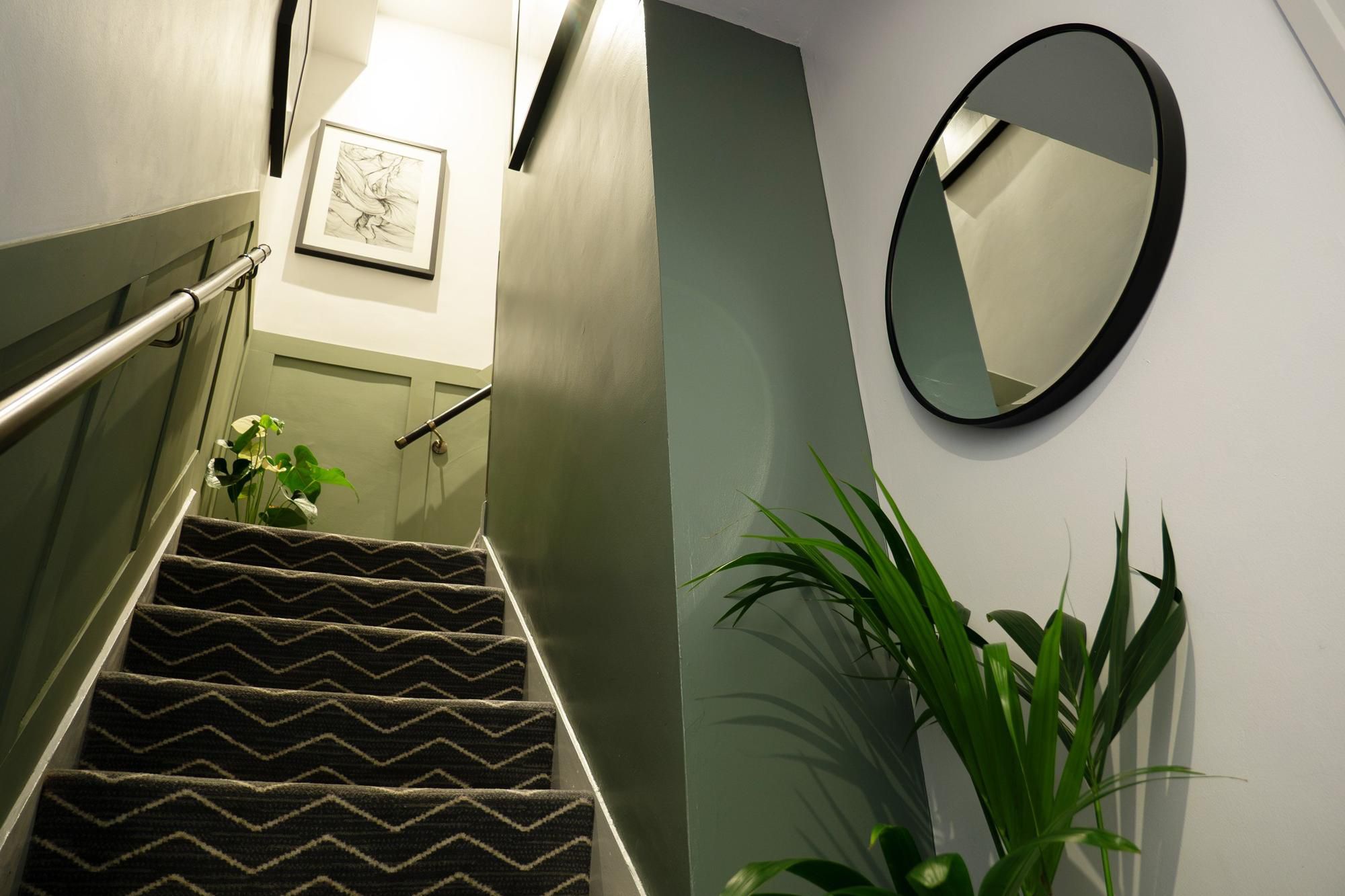 Deluxe King Suite stairway with green interiors