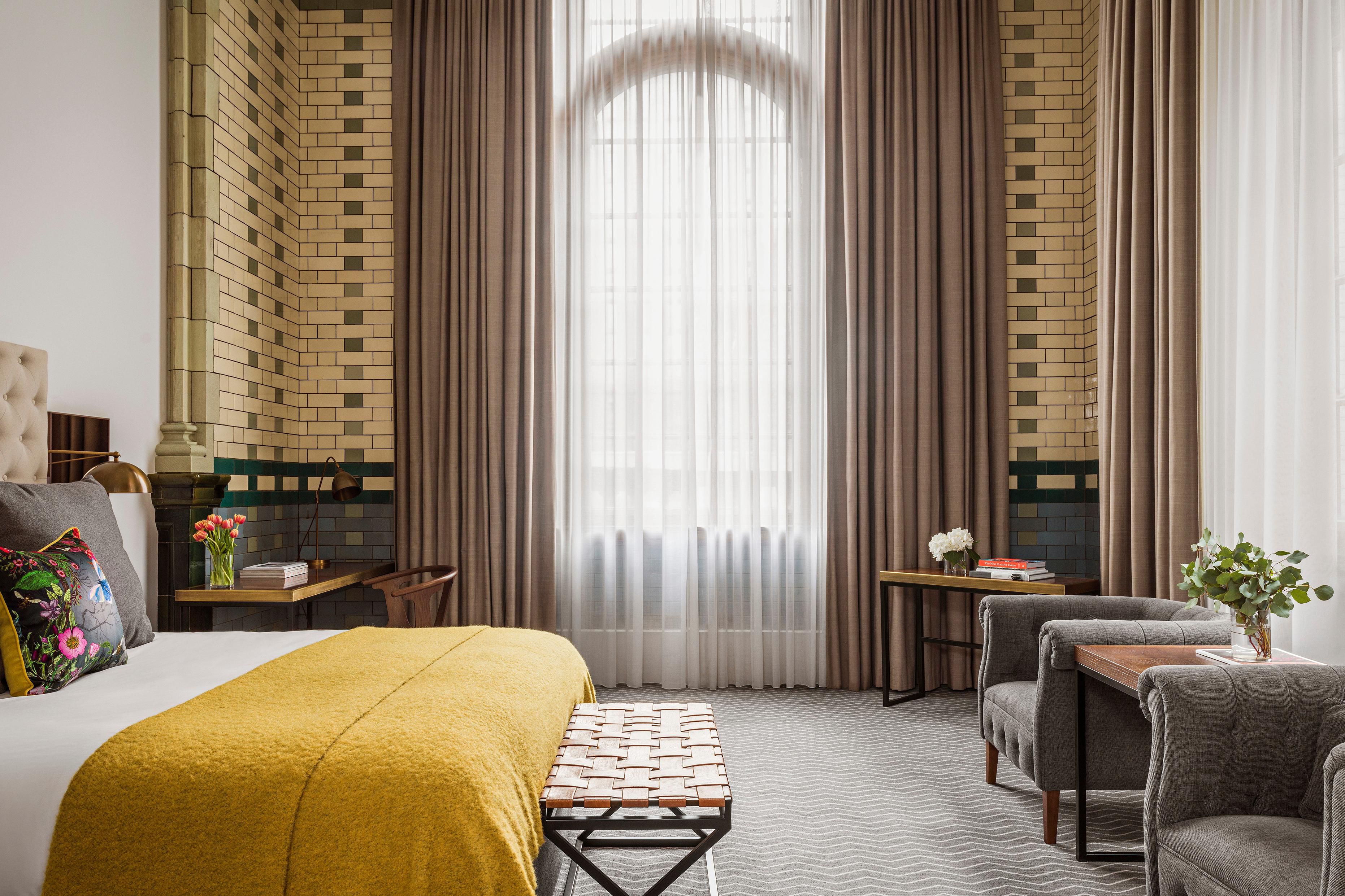 Double standard bedroom with big window and yellow throw