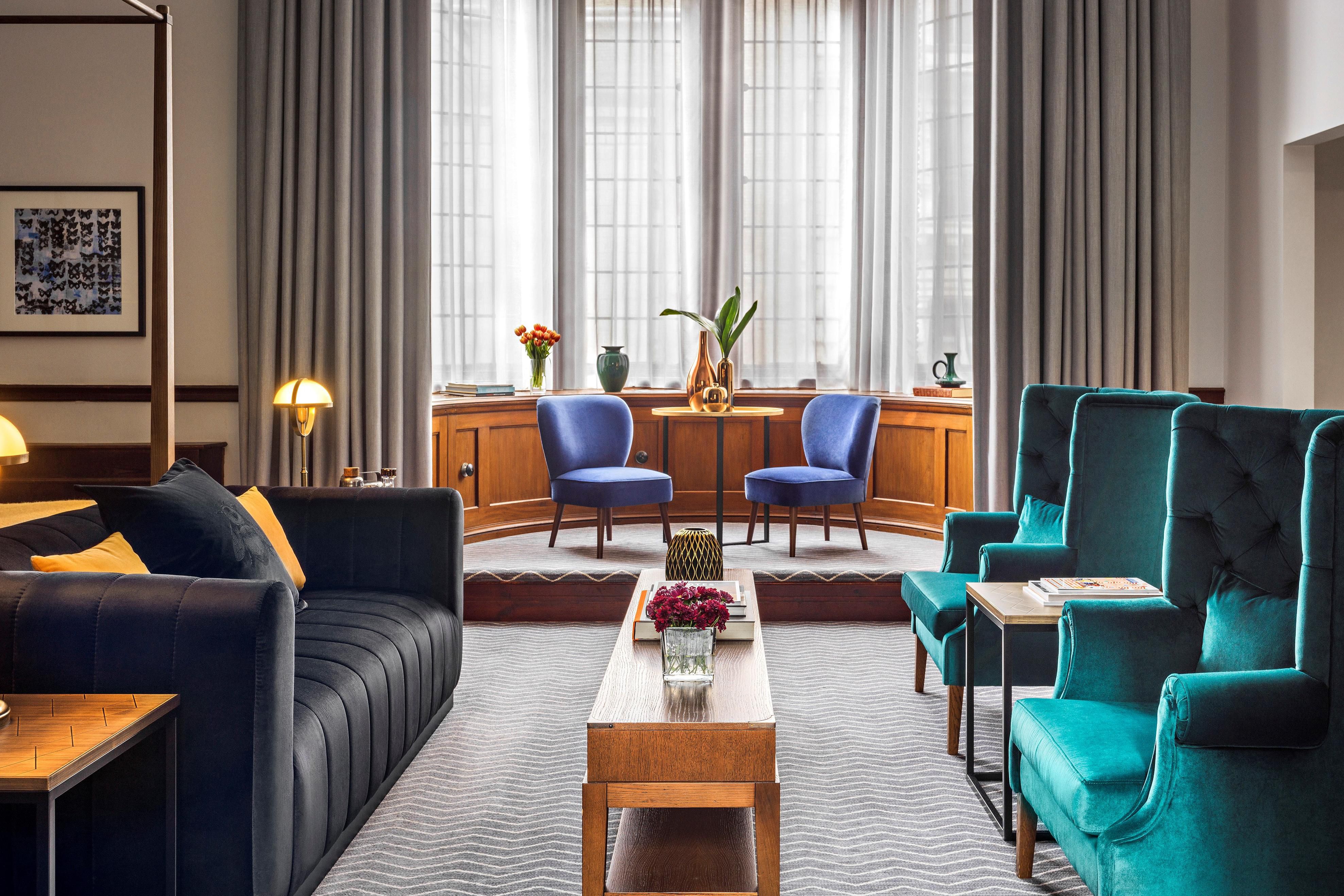 5 star hotel suite lounge area with coffee table and surrounding colourful furniture