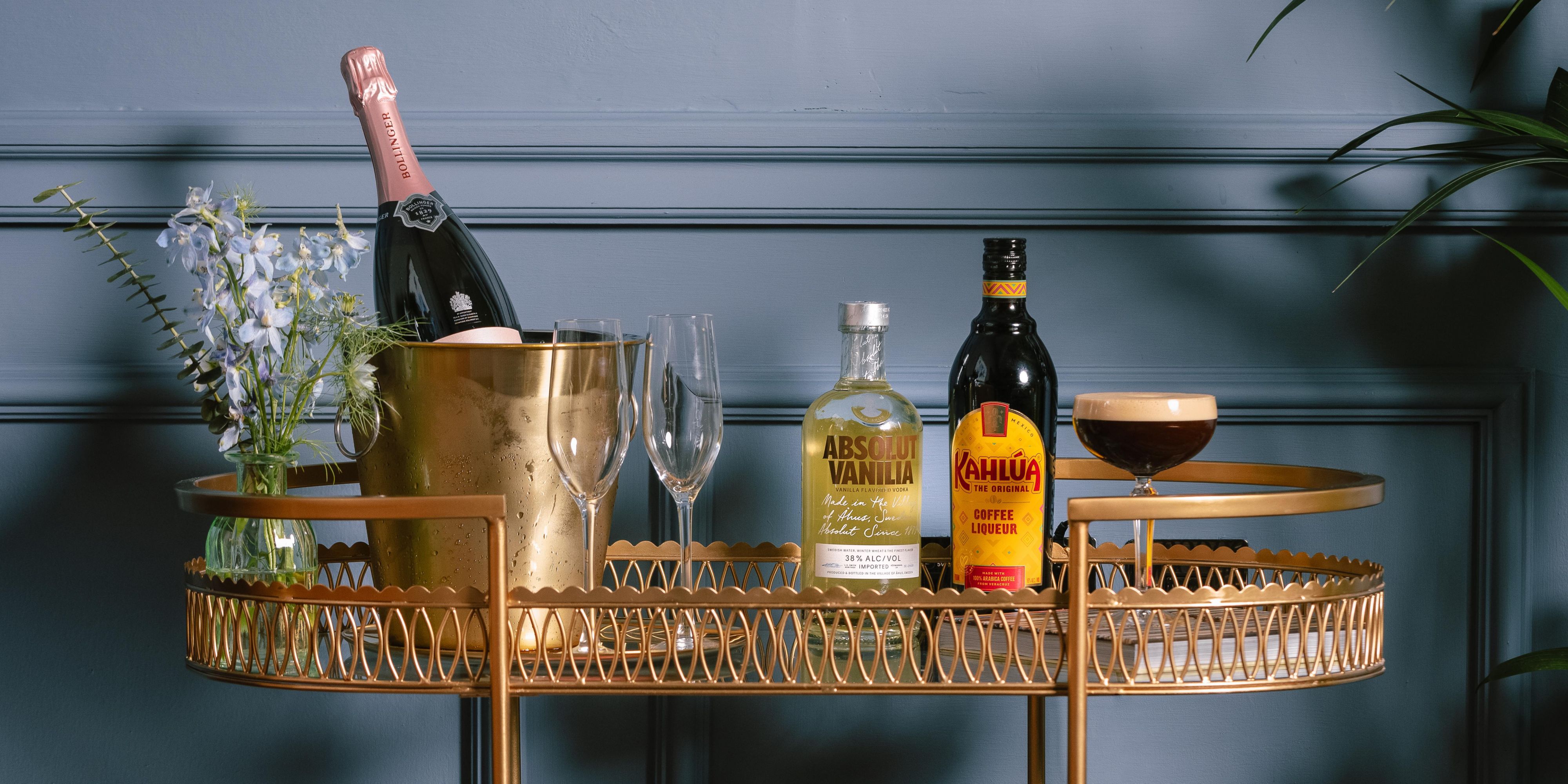 Alcoholic drinks cart featuring Absolut Vanilla Vodka, Kahlua Coffee Liqueur, and Bollinger prosecco