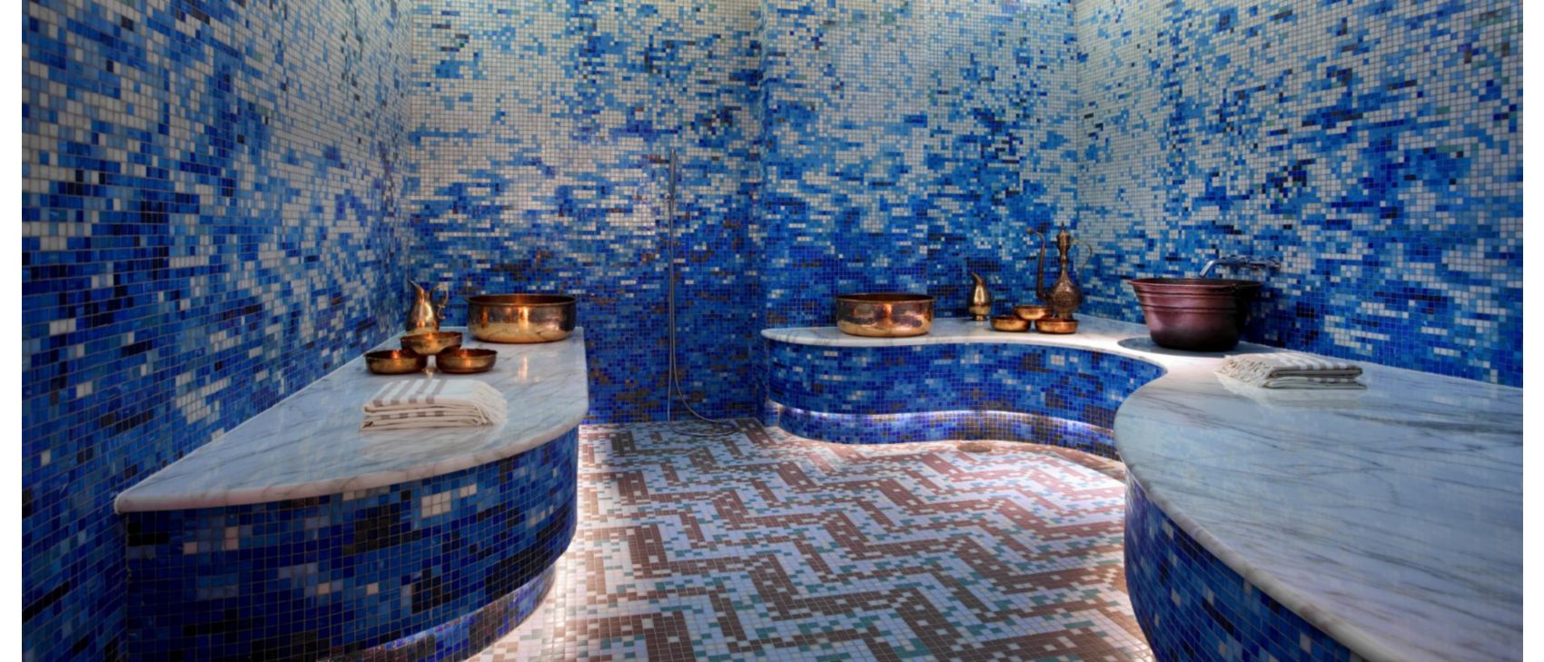 Blue tiled wall room with copper dishes