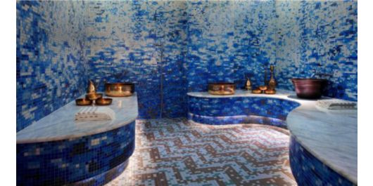 blue mosaic tiles adorn the walls and ceiling in this spa