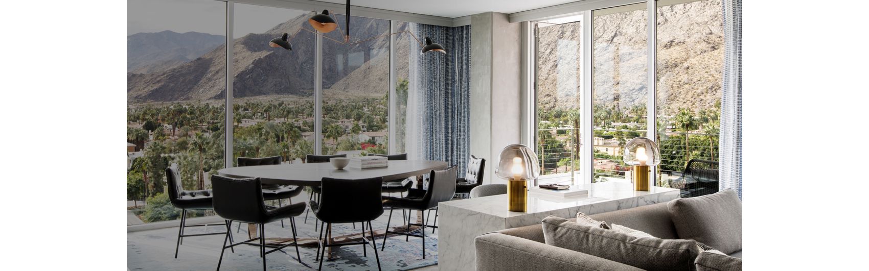 suite sitting area with floor to ceiling windows and desert mountain views