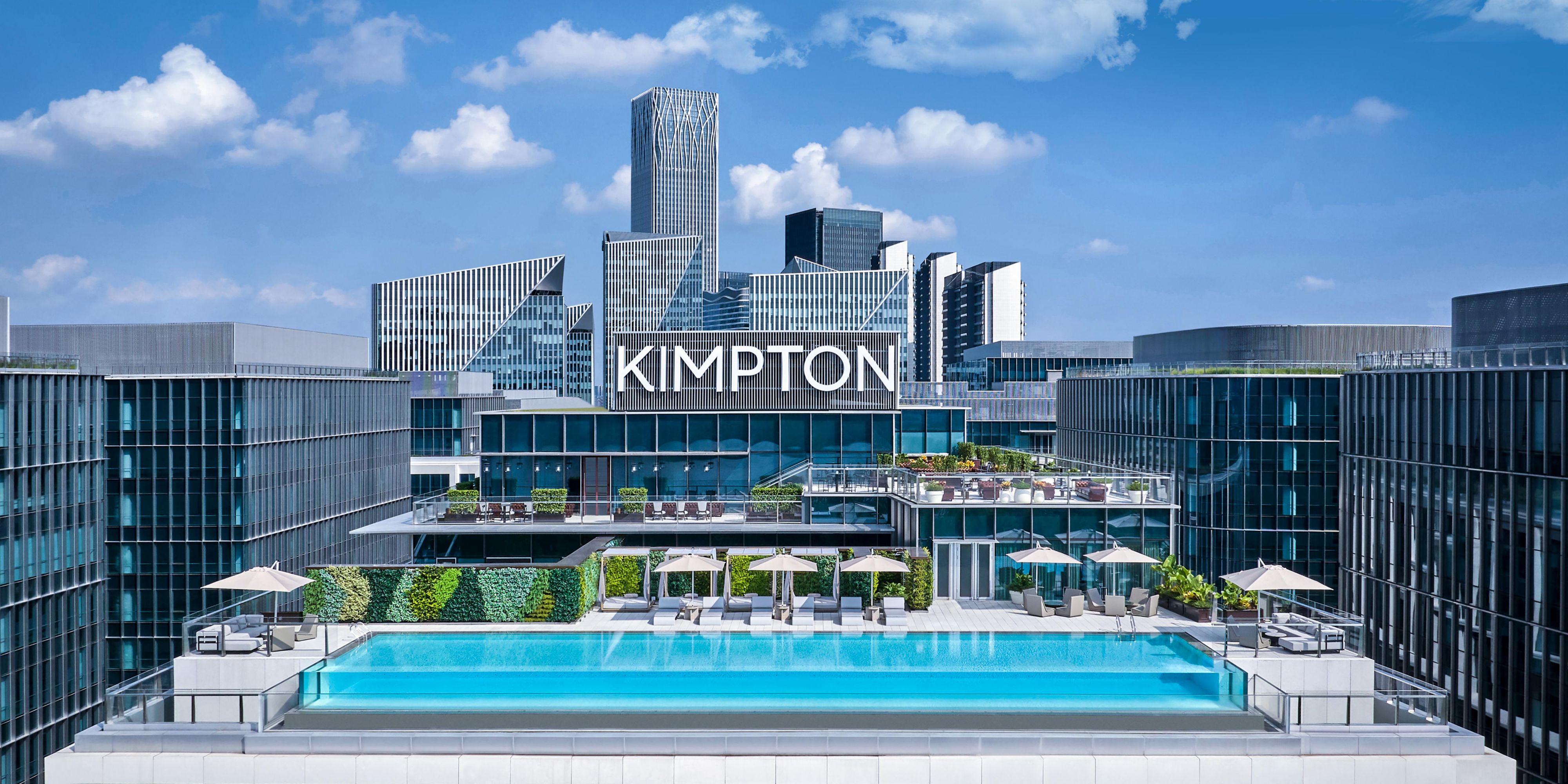 The rooftop infinity pool is set amidst a lush tropical garden, where guests can rise to a view of the Huangpu River, the West Bund and the city.