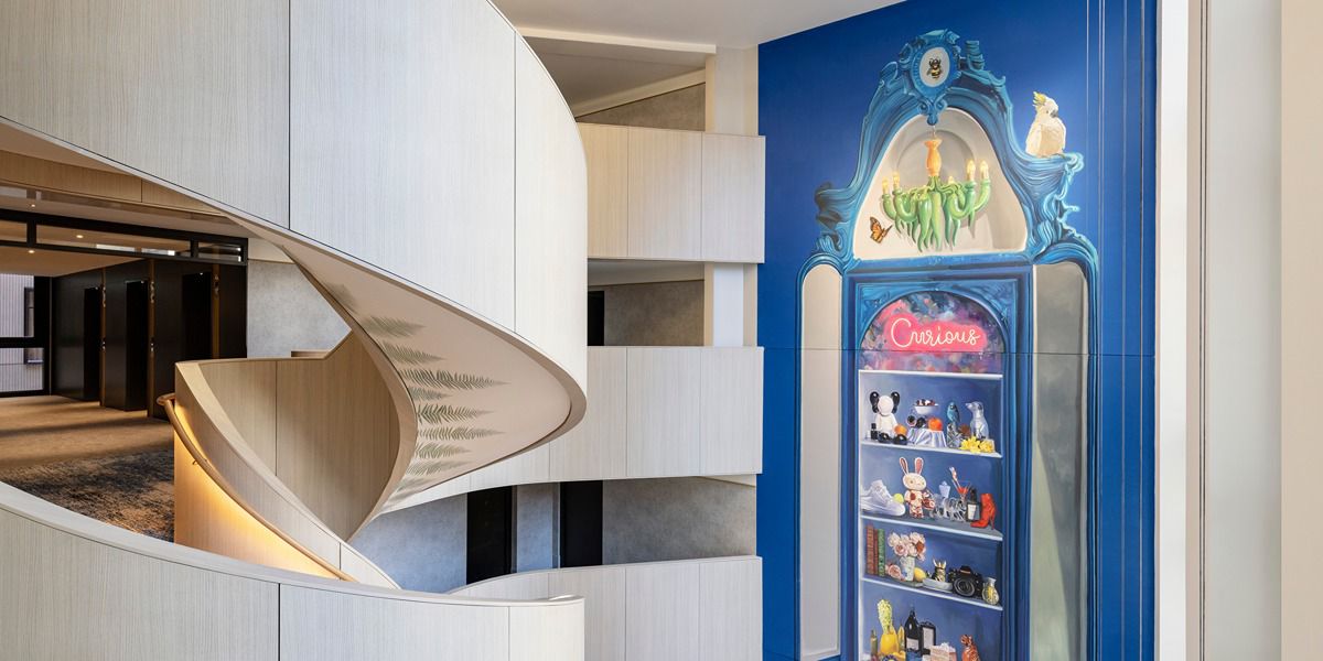 Modern hotel lobby with spiral staircase and display