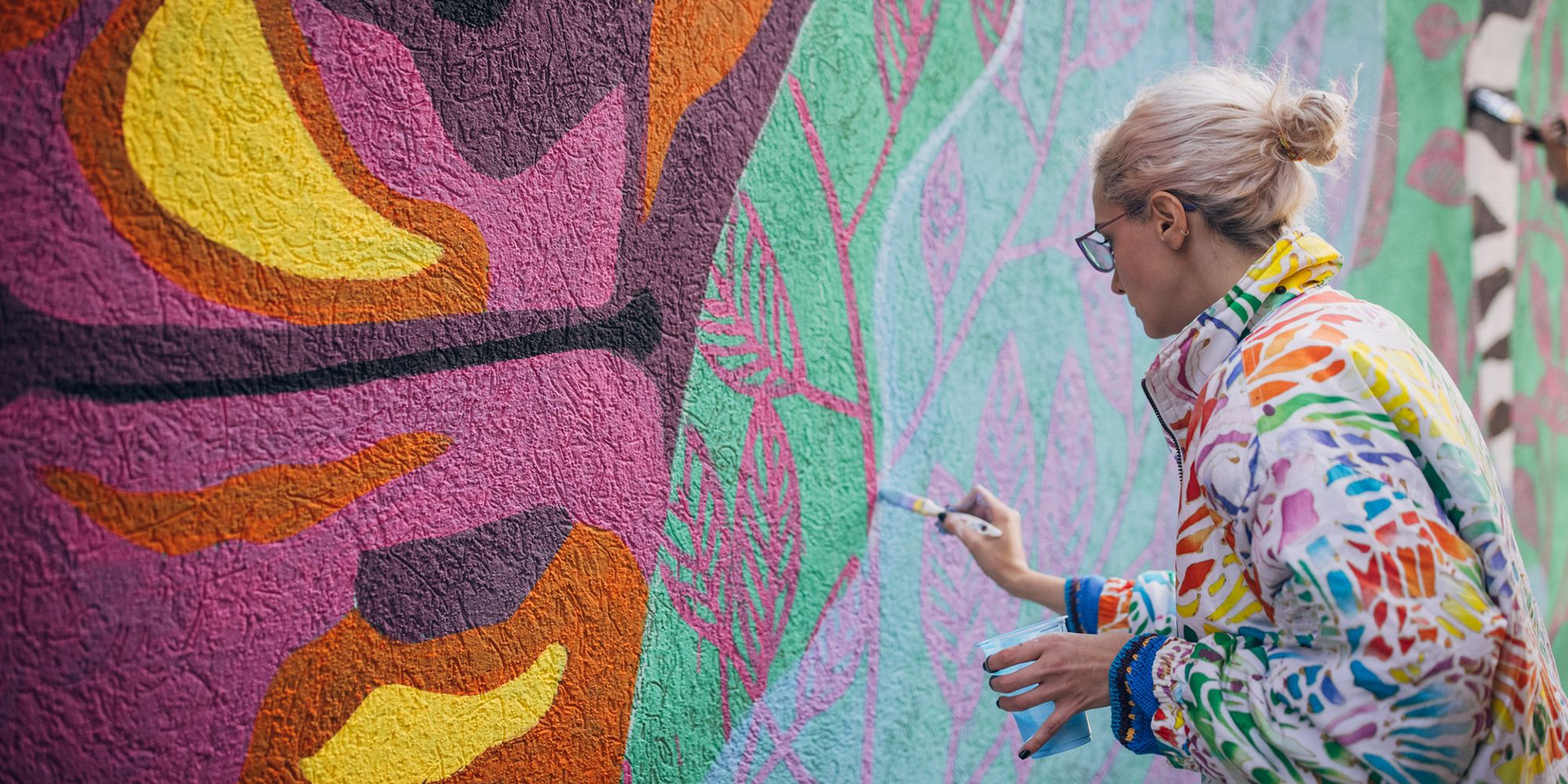 Woman painting on the Crowley road murals