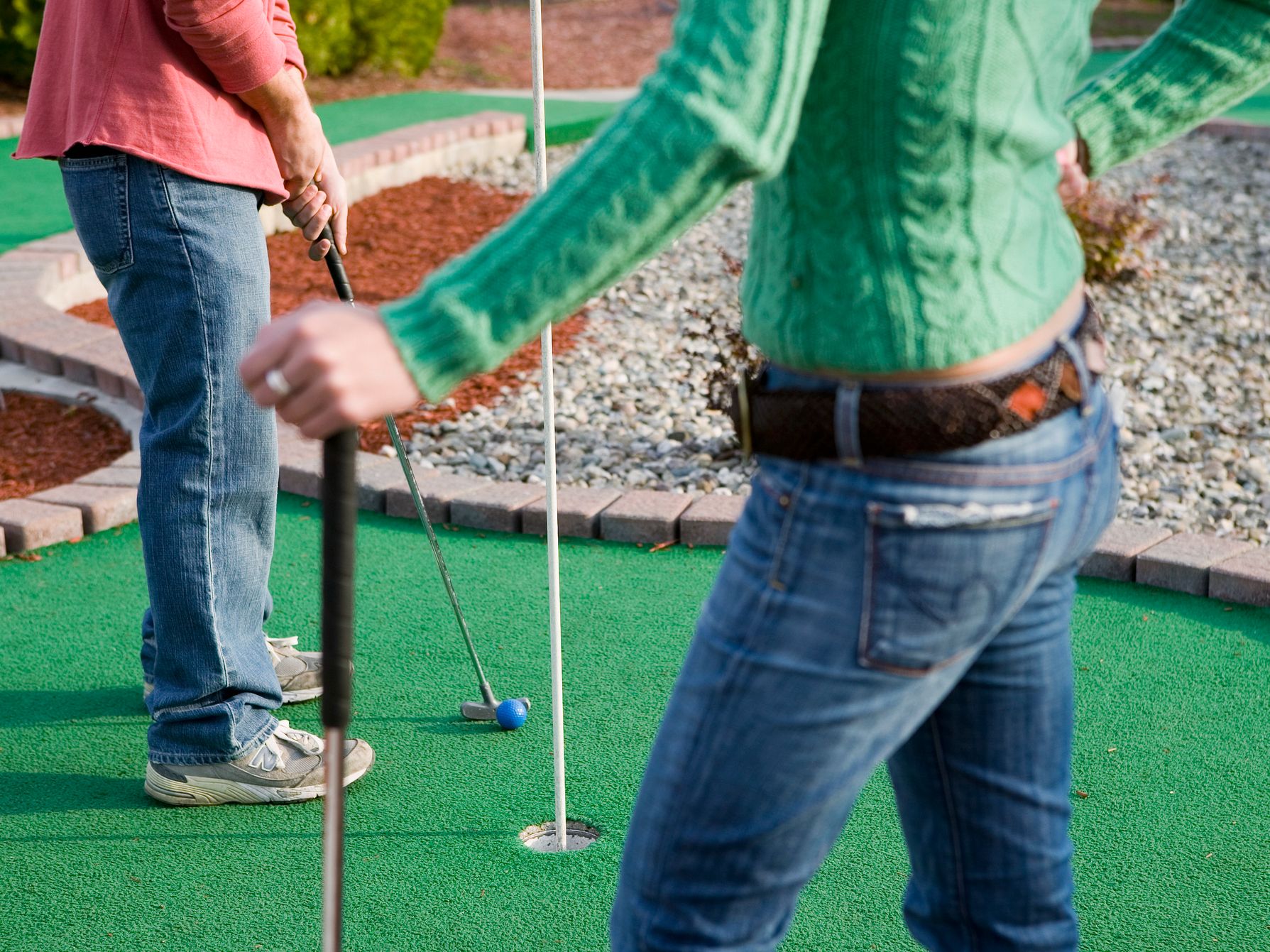 Men playing miniature golf