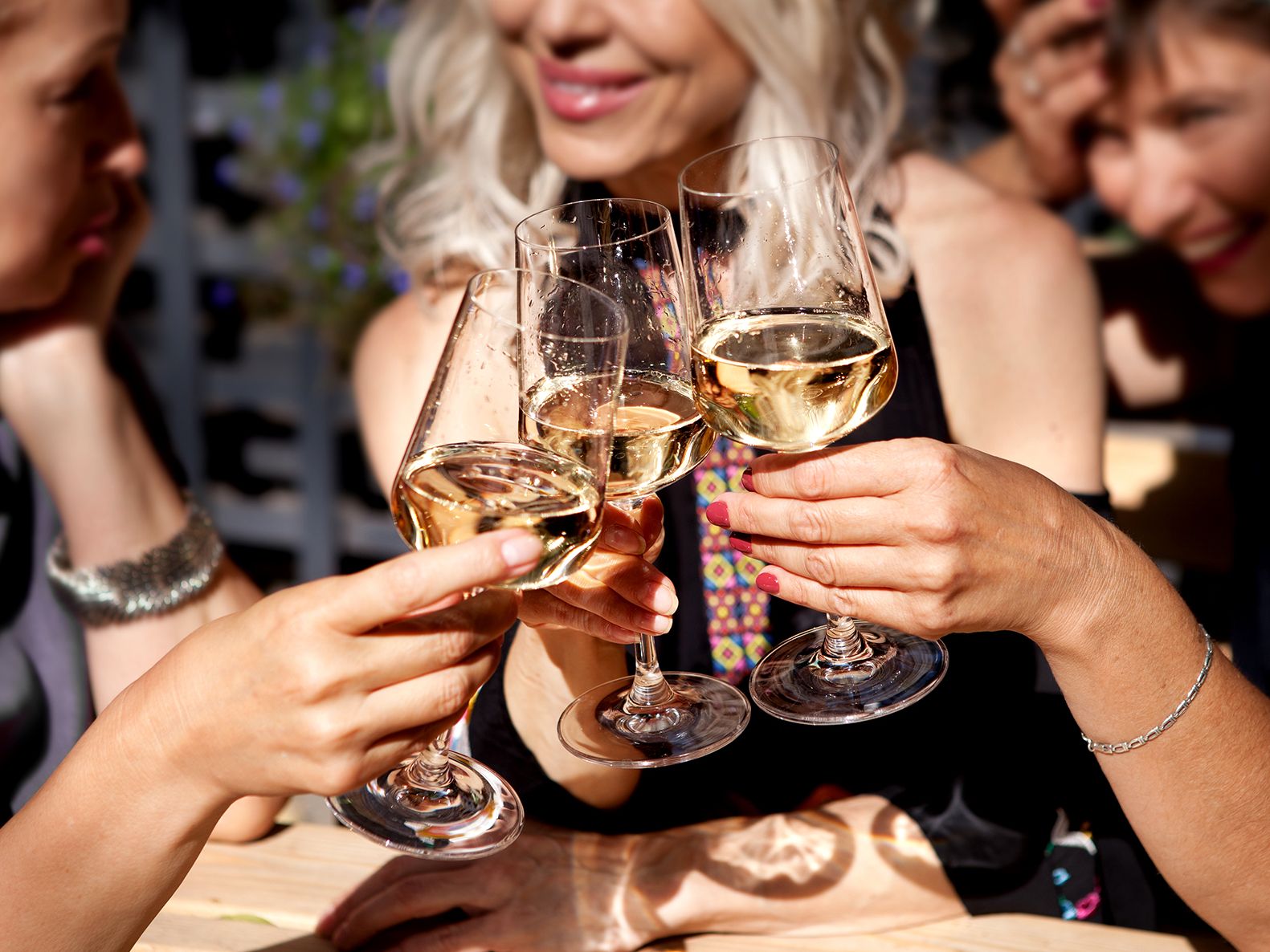 Women cheersing with wine glasses