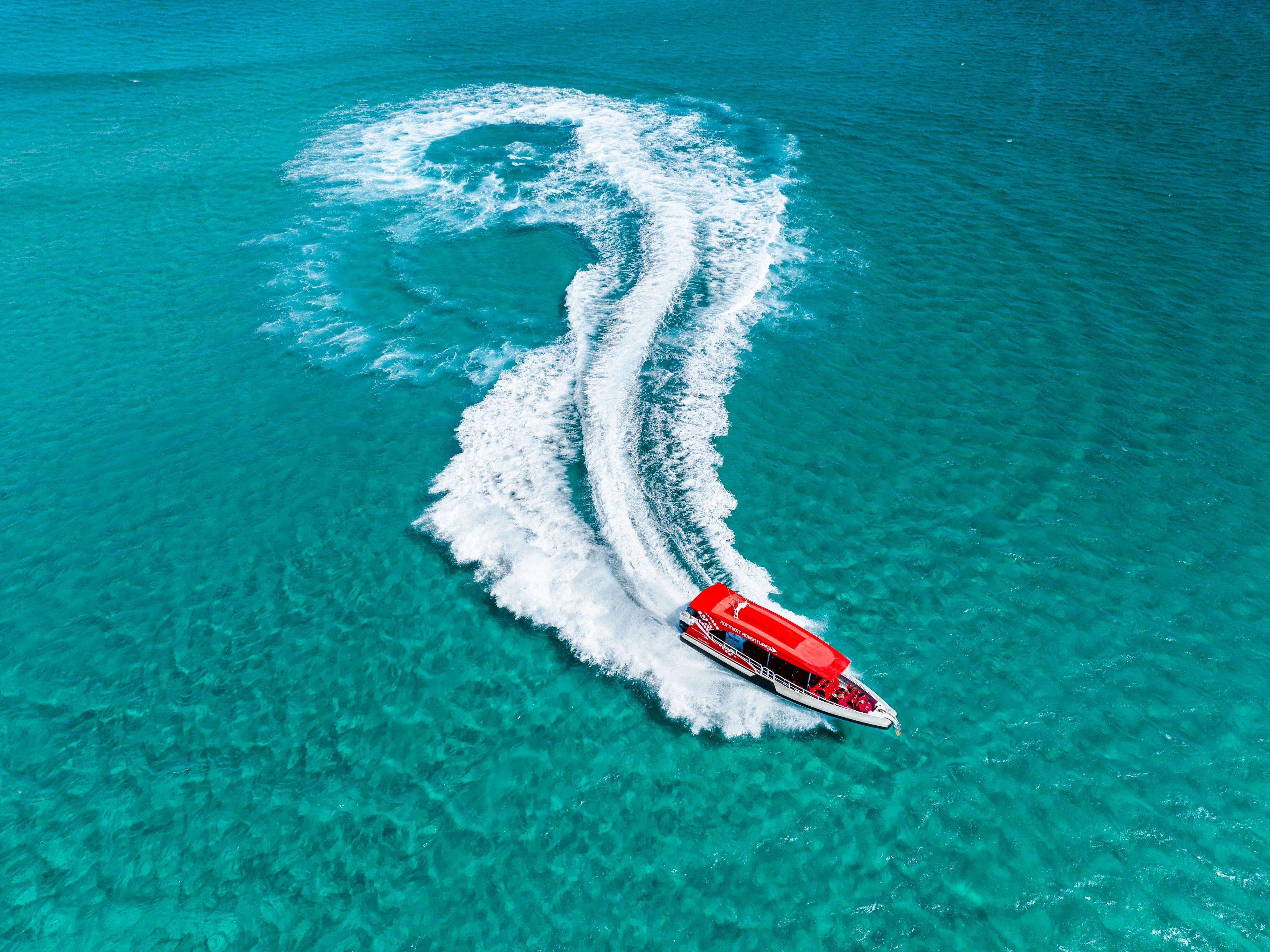 Boat gliding through the ocean at Rottnest Island.