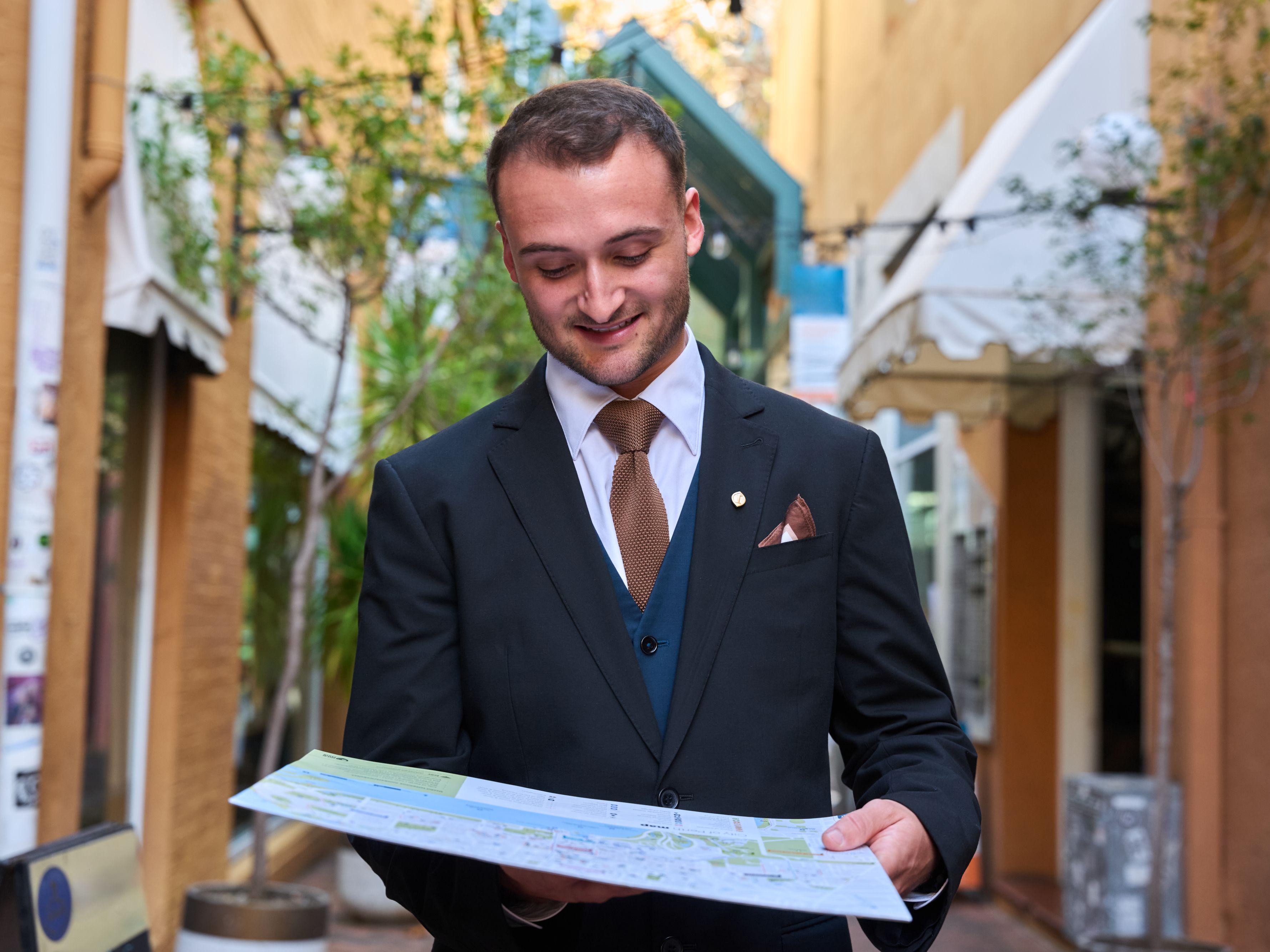 Concierge looking at city map.