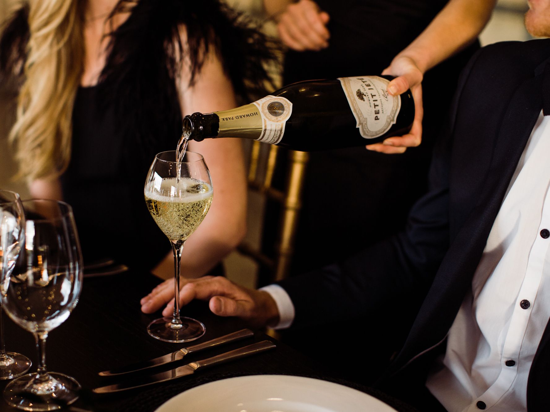 Guests enjoying sit down dinner and champagne