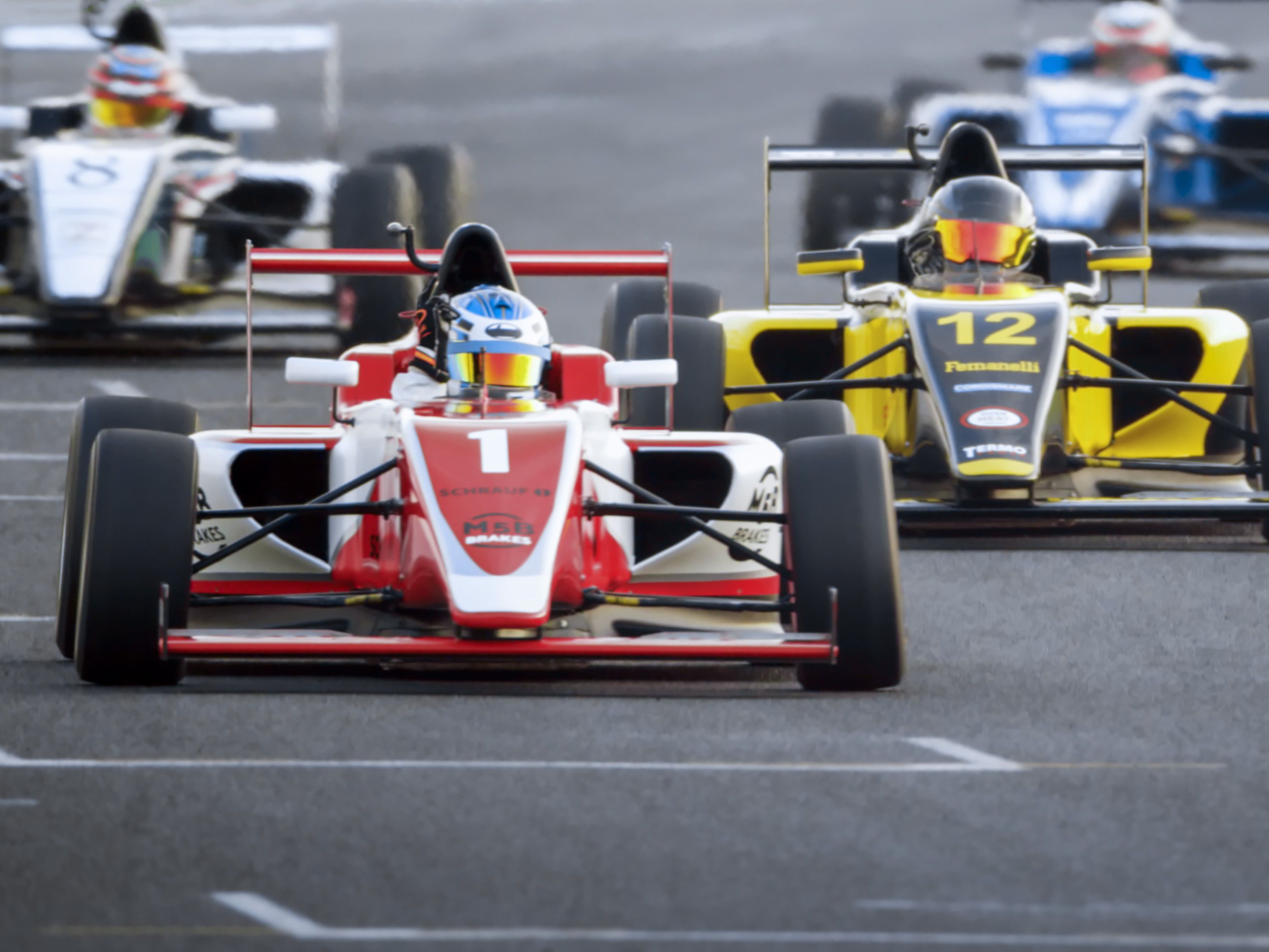 Race cars racing on a raceway