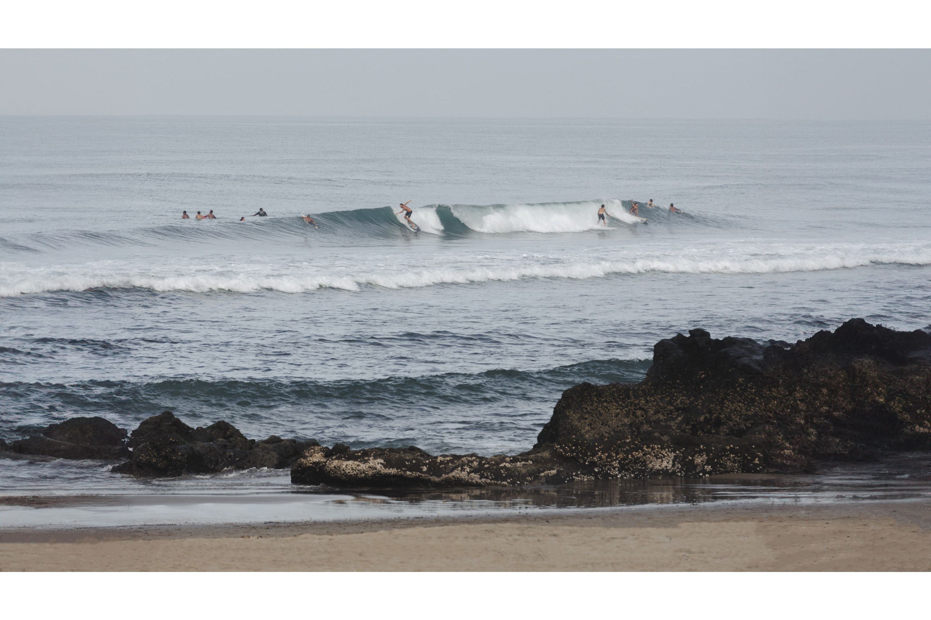 People enjoying the beach at dusk