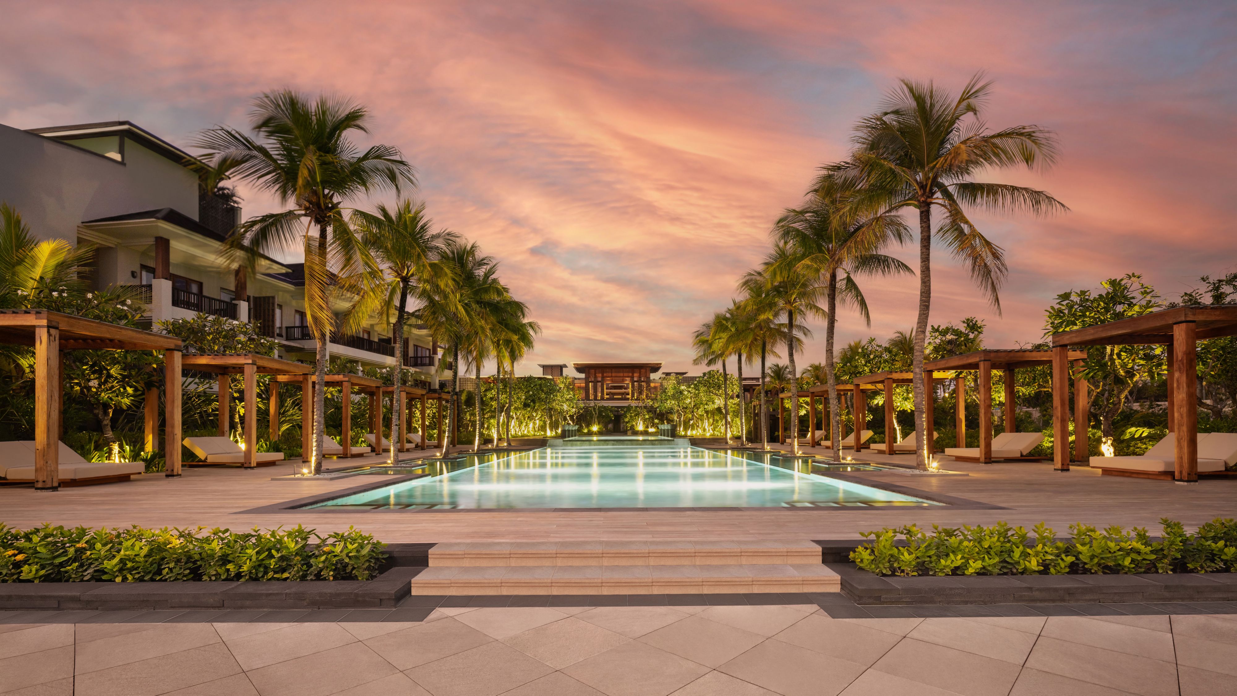dramatic uplighting on a beautiful open air spa with walking paths through water