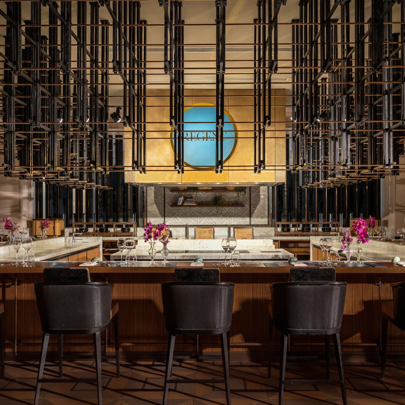 A master chef's table, artfully set, for guests to immerse in a dining experience.