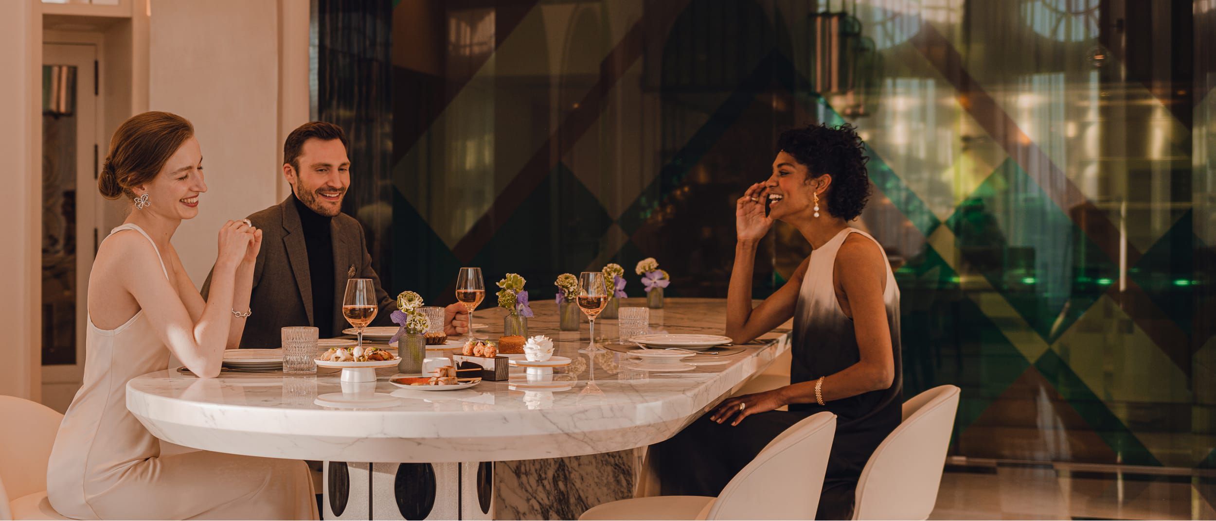 A group enjoying a meal together with small dishes for sharing tastes.