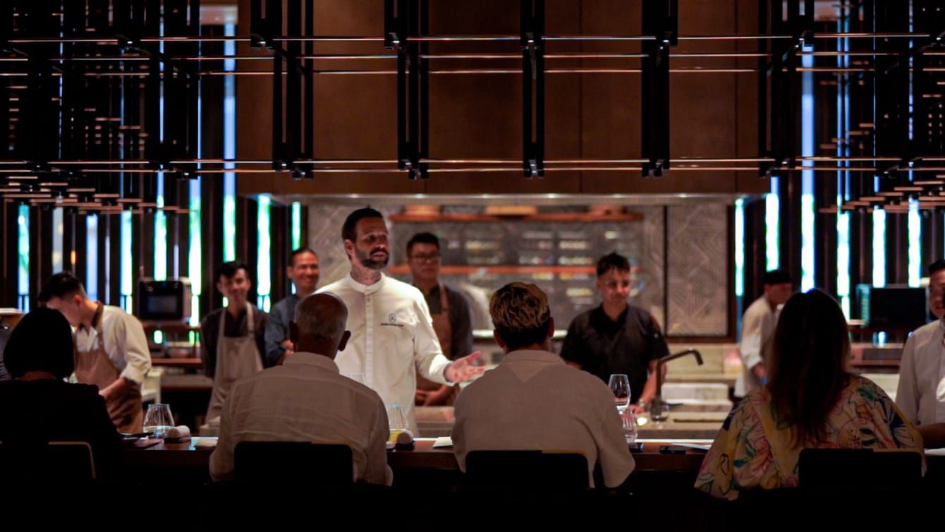 A celebrity chef engages with guests before he prepares their feast.