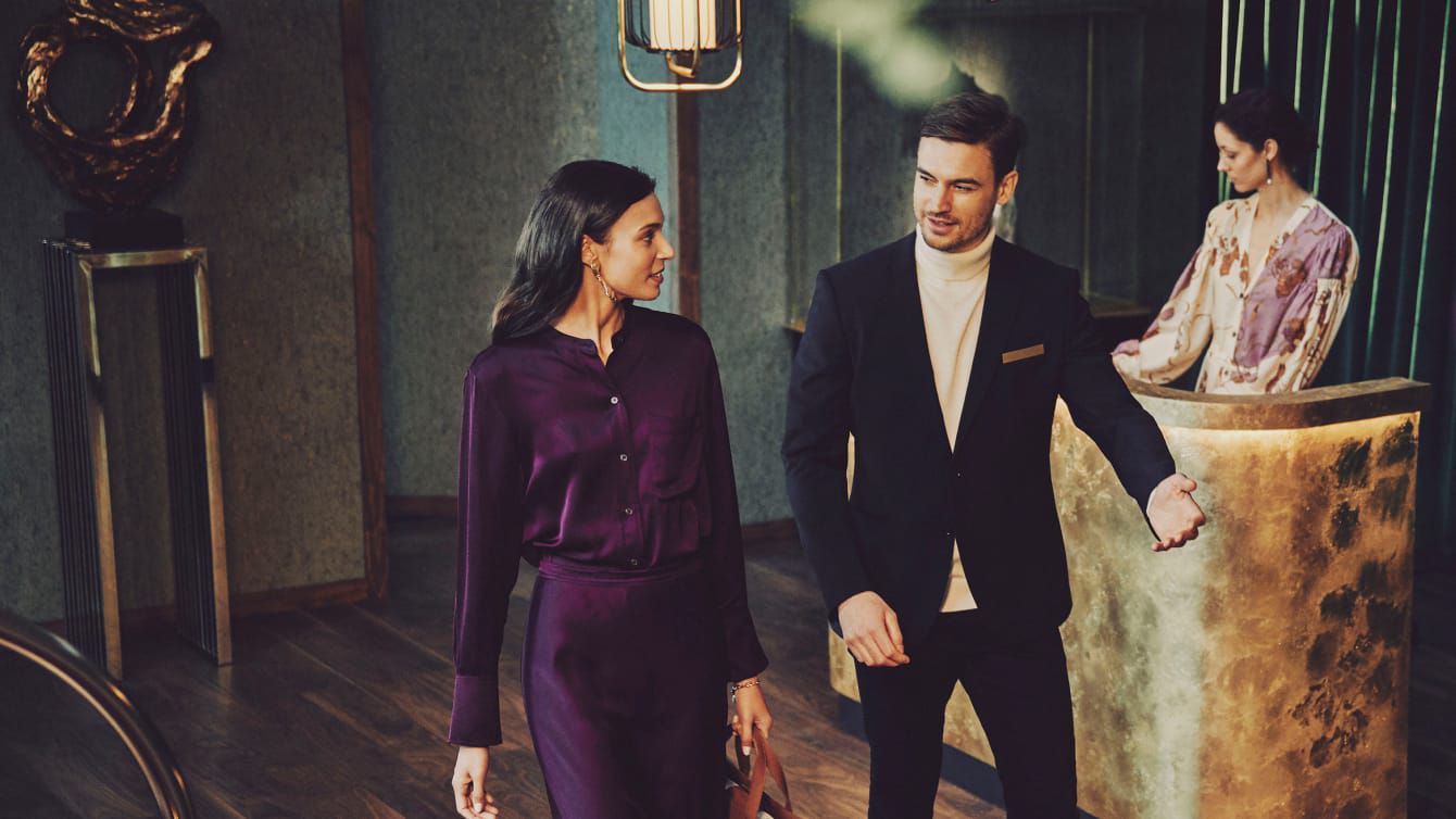 A Regent concierge escorting a guest to her destination.