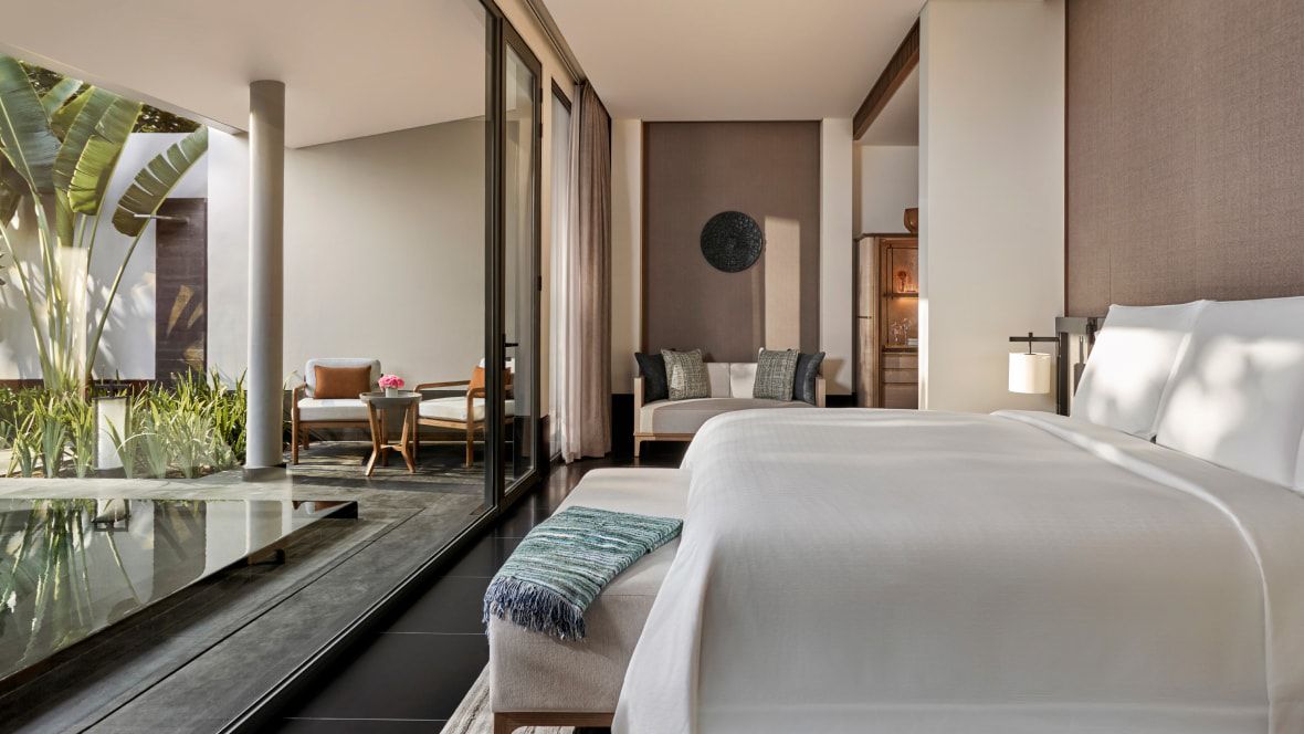 indoor outdoor suite with water and palms