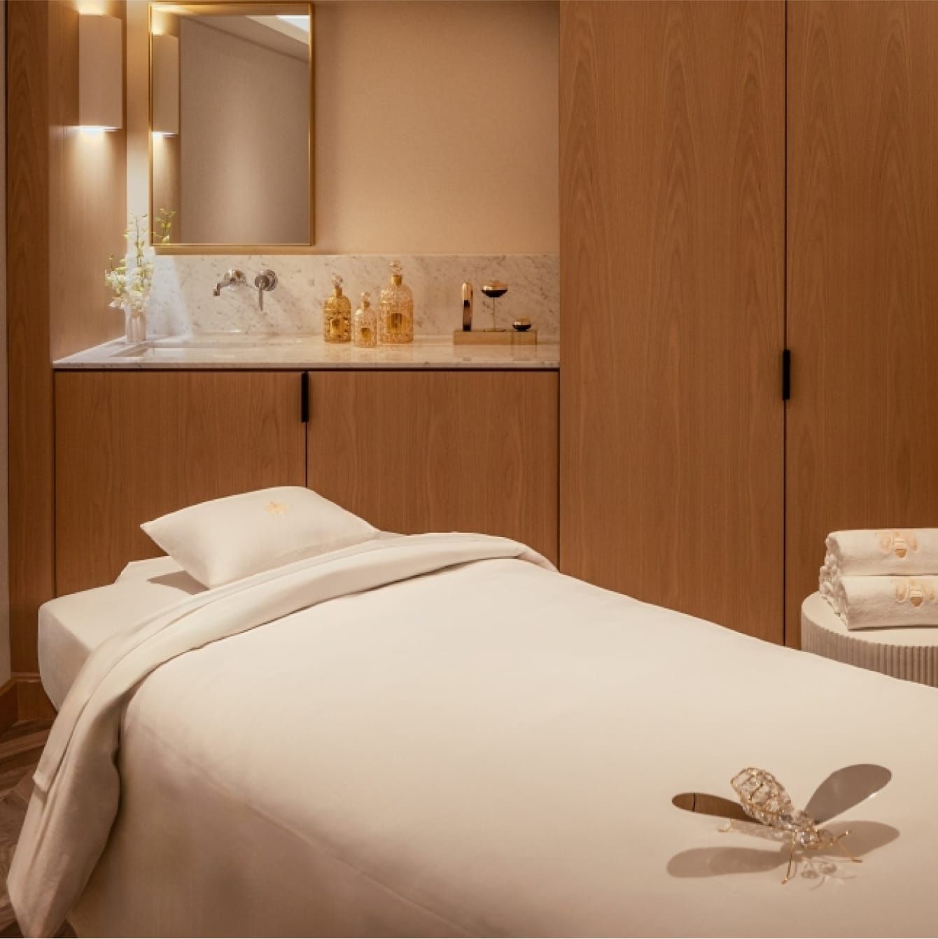 An elegantly lit spa treatment room with massage table.