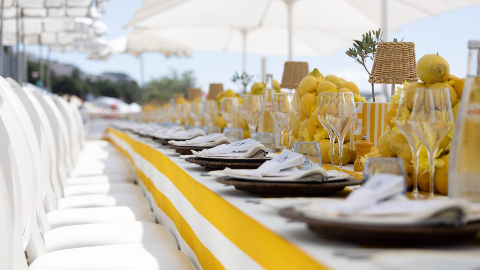 outdoor restaurant with long table, yellow and white decor