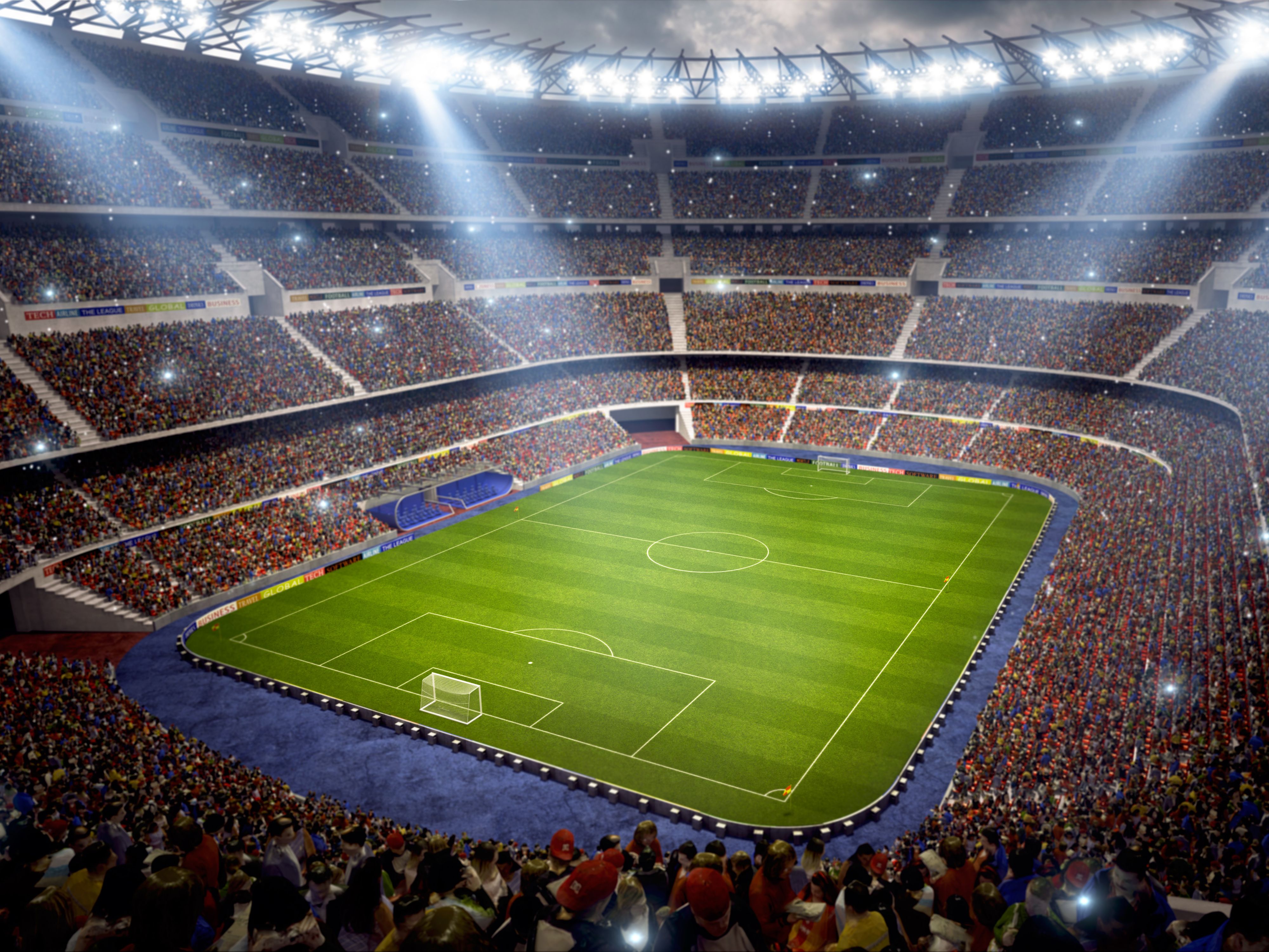 Wide view of a crowd and an empty soccer pitch