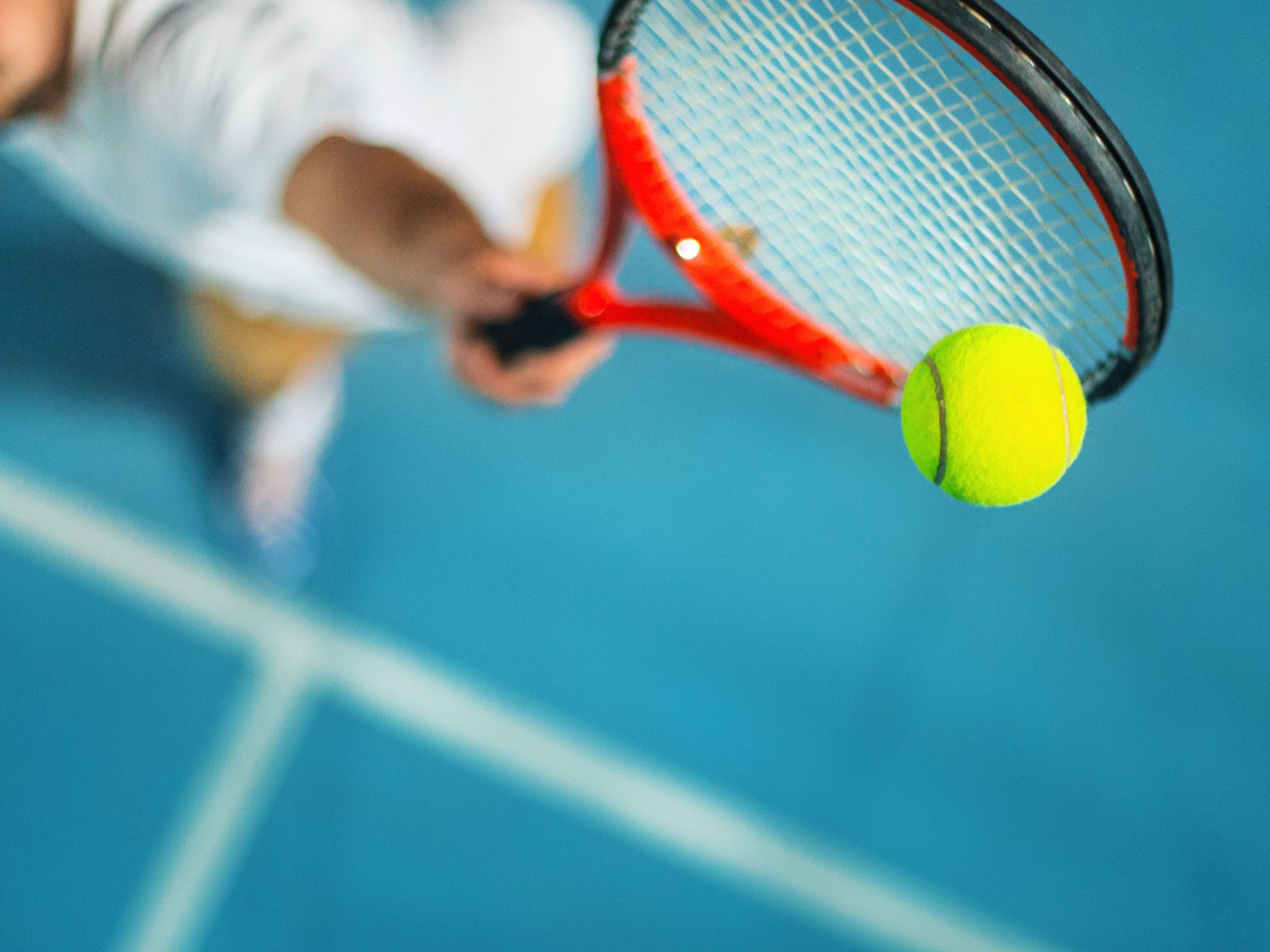 Tennis player hitting tennis ball