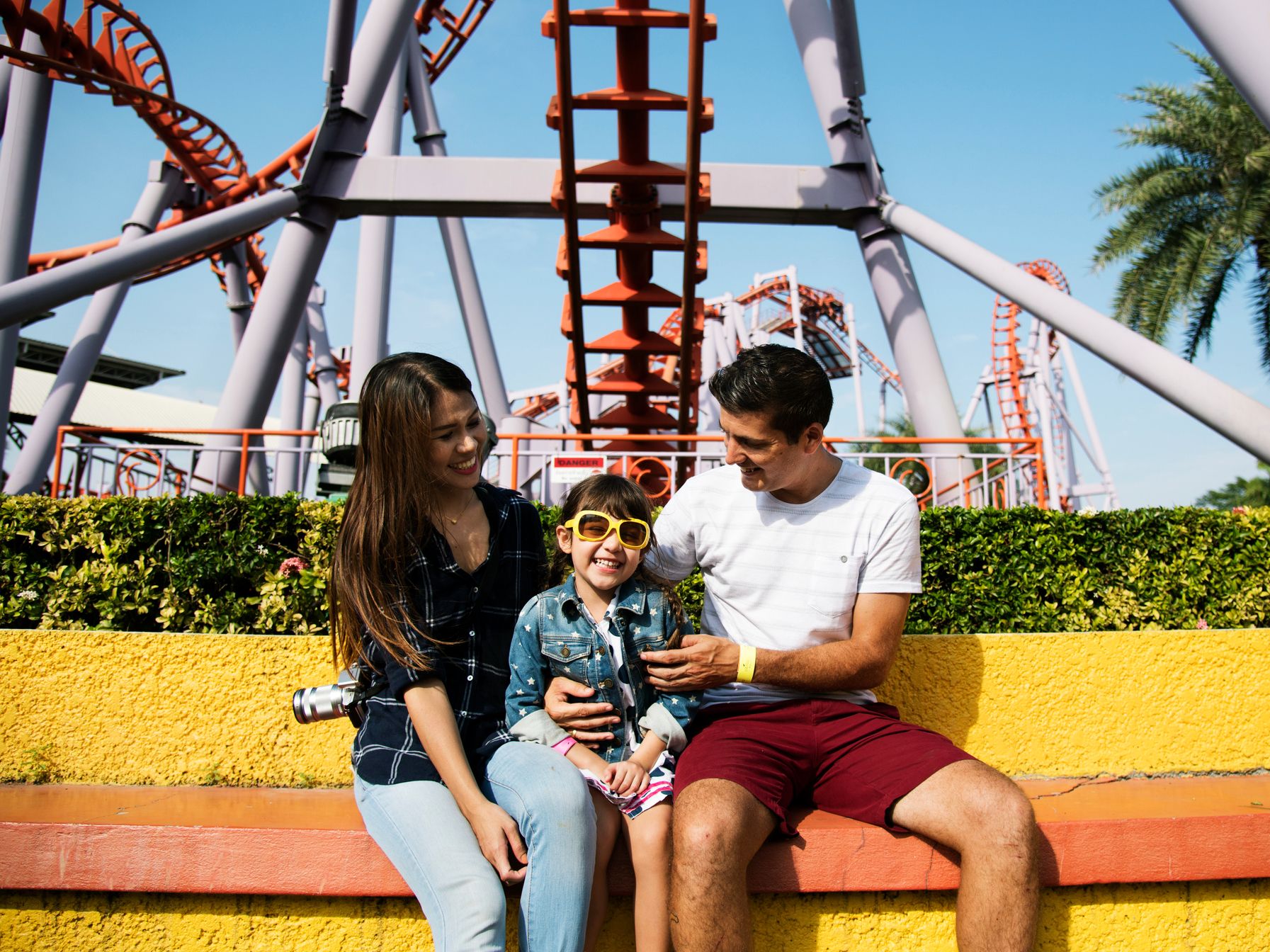 Family sitting at an amusement park