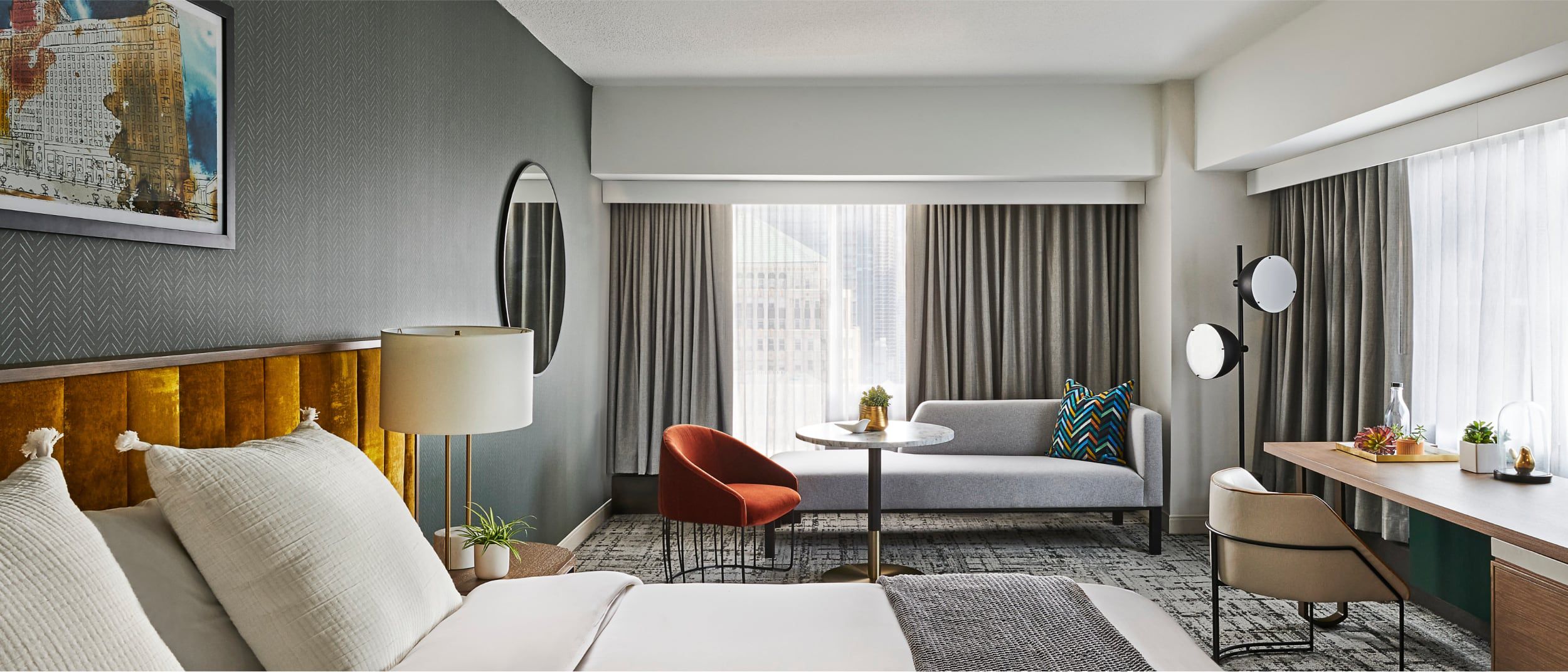 A wood-panelled cafe bar with a marble top, red stools, greenery overhead and a neon flamingo sign.