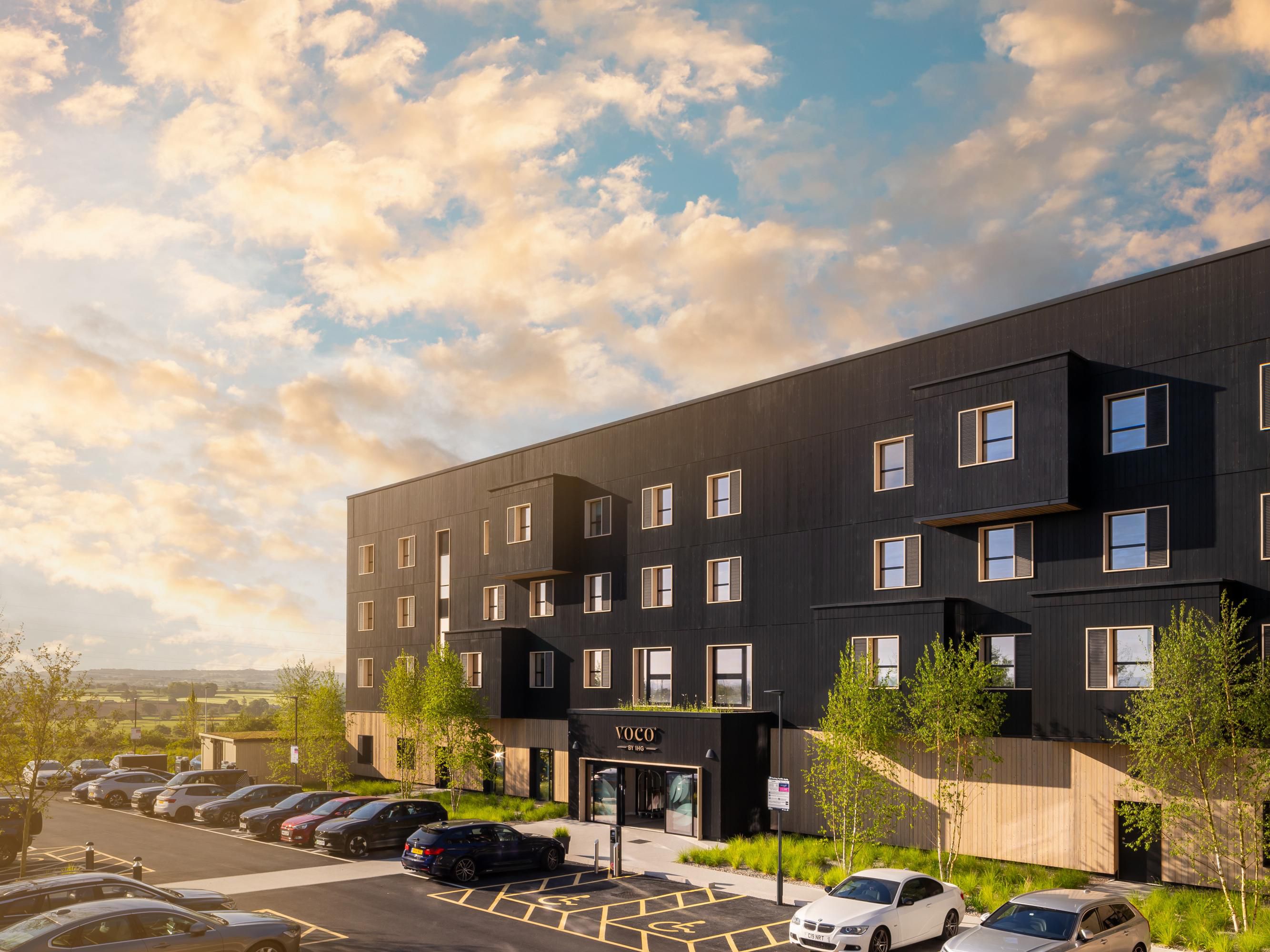 Hotel exterior made of solar panels and timber cladding 