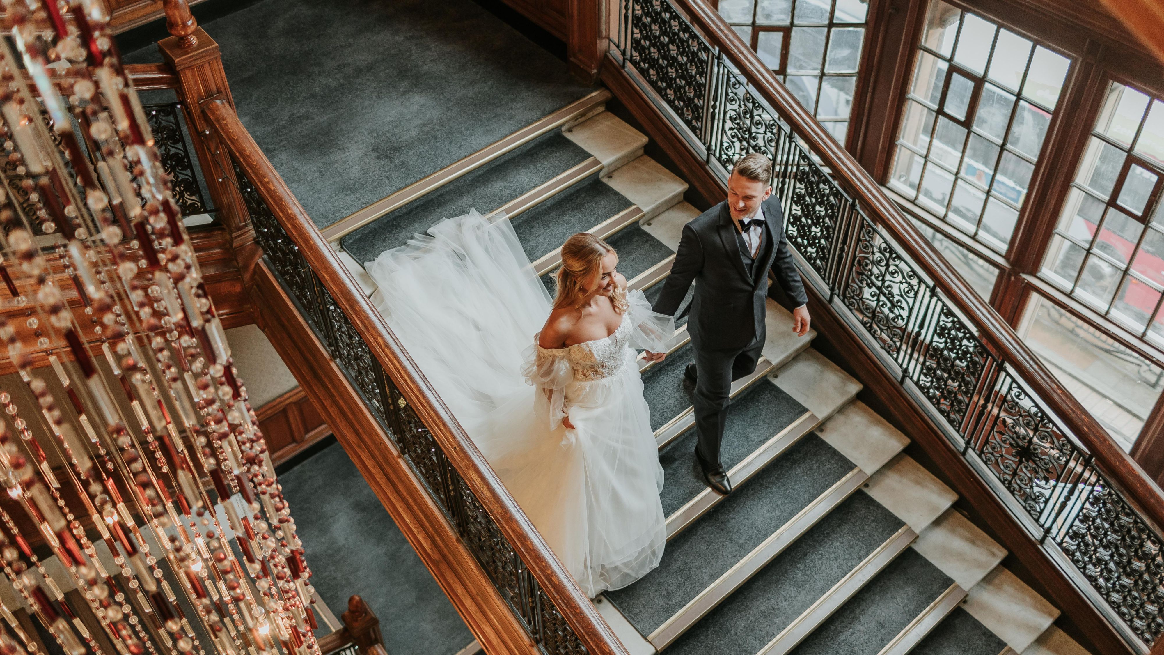 Bride and Groom walking down the stairs