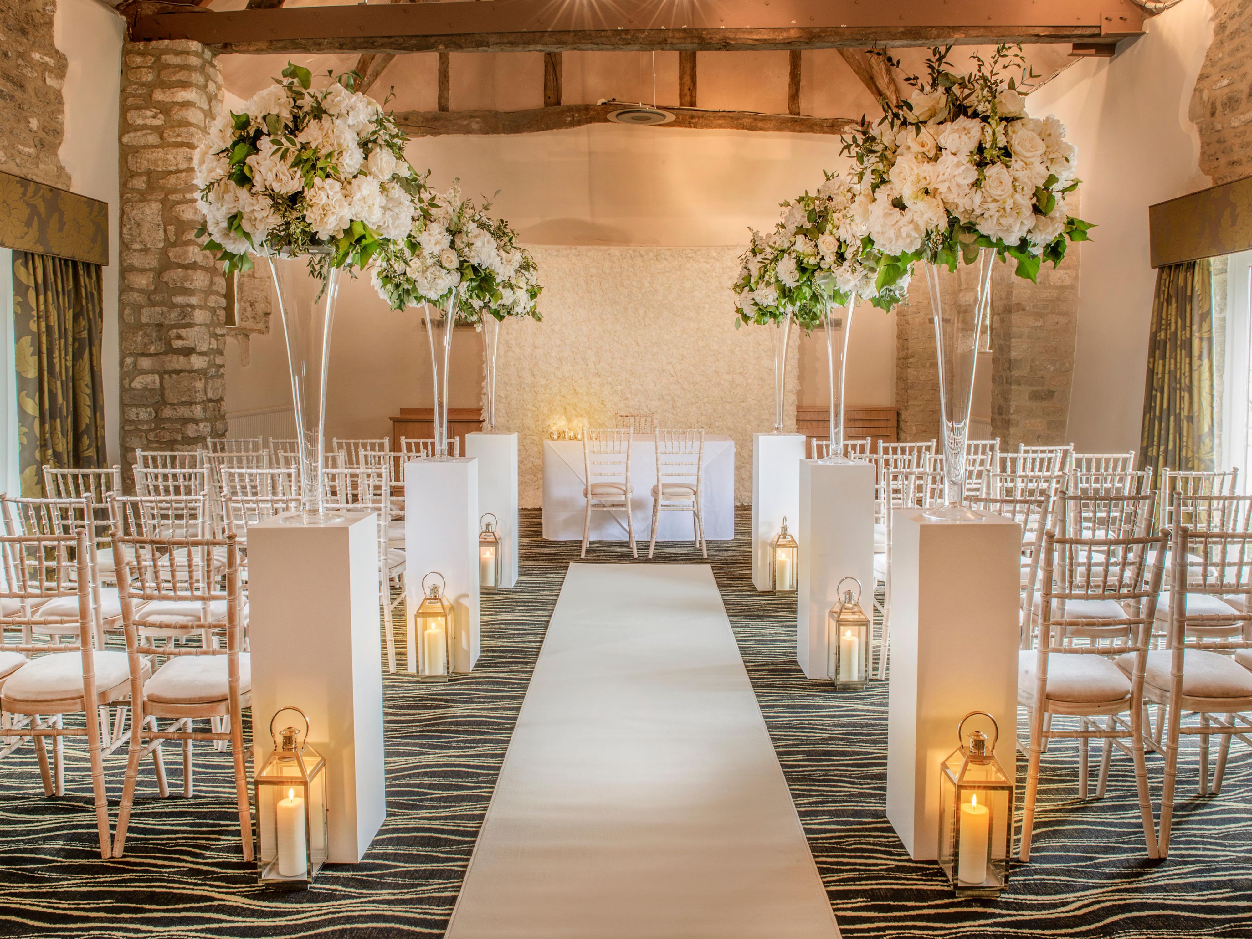 Say 'I do' at voco® Oxford Thames. The tree-lined driveway unveils Cotswold stone buildings, medieval barns, and a Grade II listed 15th-Century manor house. Set on 30 acres by the River Thames, it's the perfect backdrop for your wedding day.