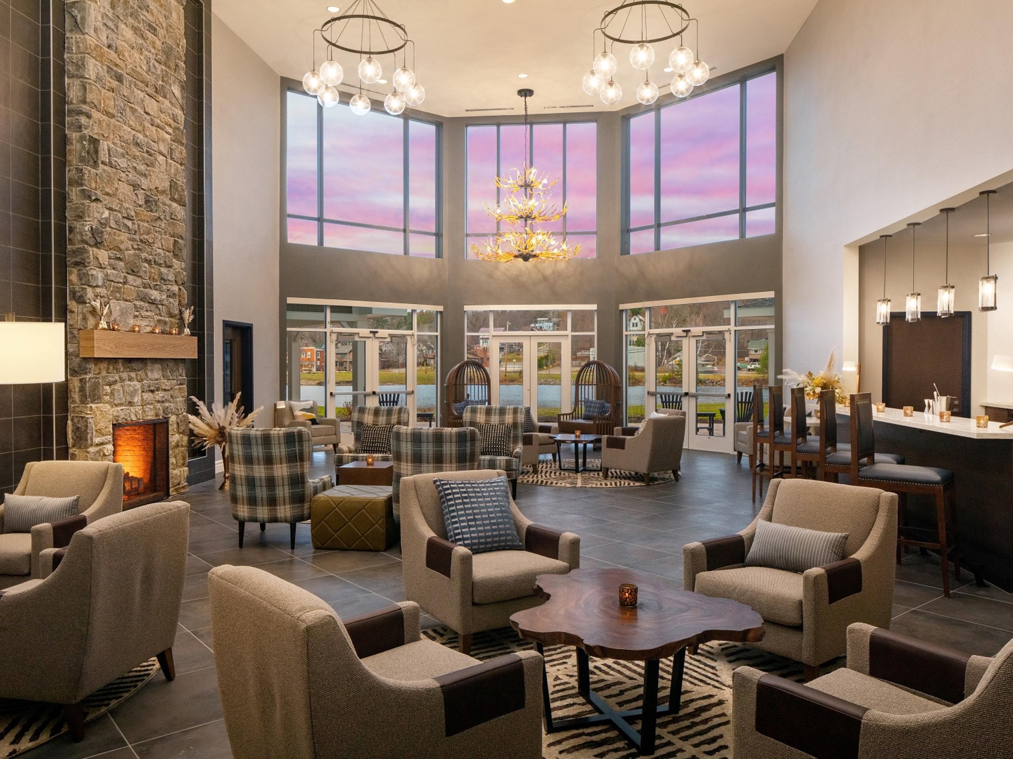 Relax in the solarium’s sunlit comfort, a serene spot to unwind after exploring the Adirondacks. This bright, airy space at voco Saranac Lake NY - Waterfront invites guests to soak in natural light and Lake Flower water views year-round.